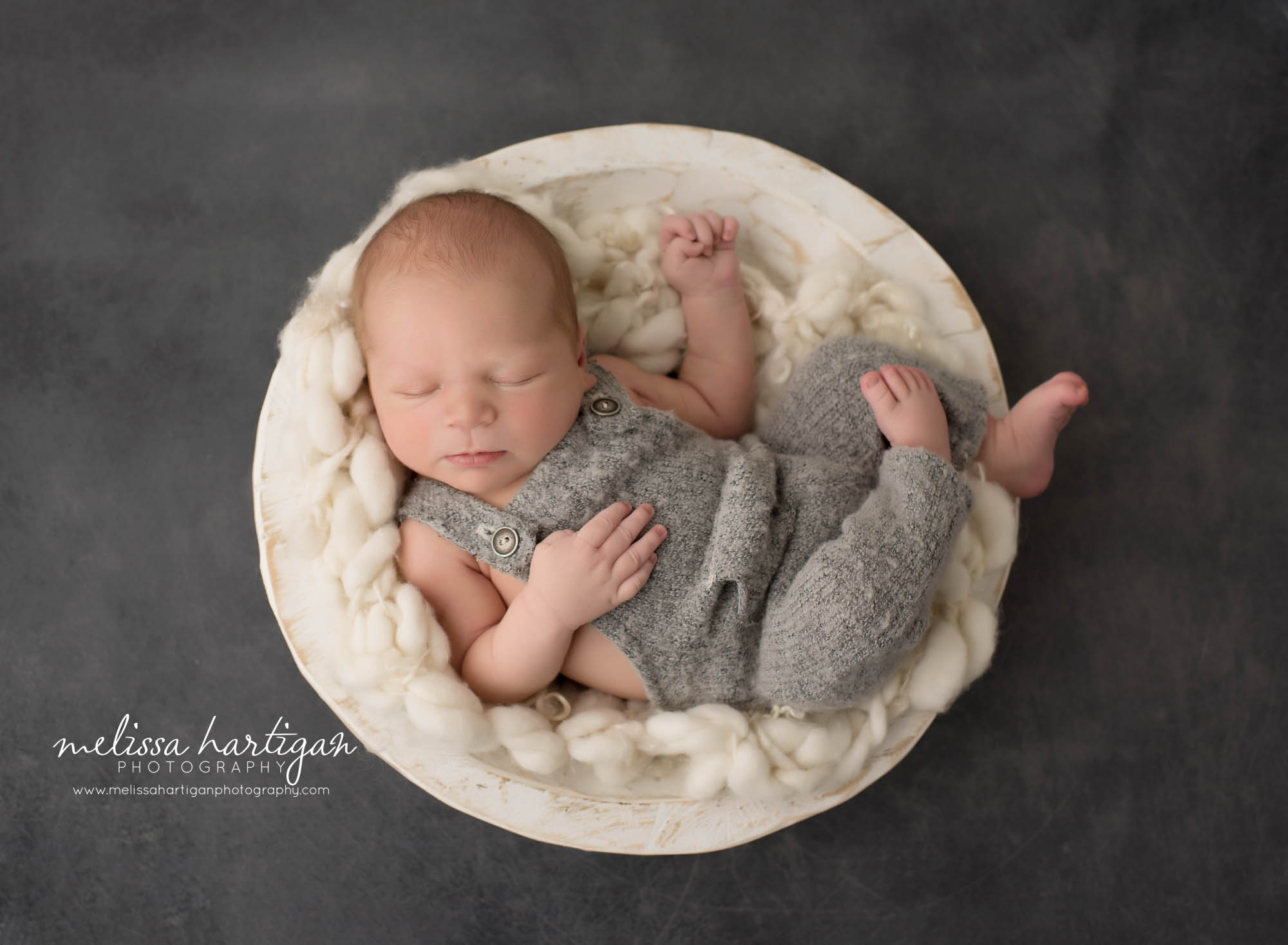 newborn baby boy wearing gray outfit posed in cream wooden bowl ct newborn photorgapher