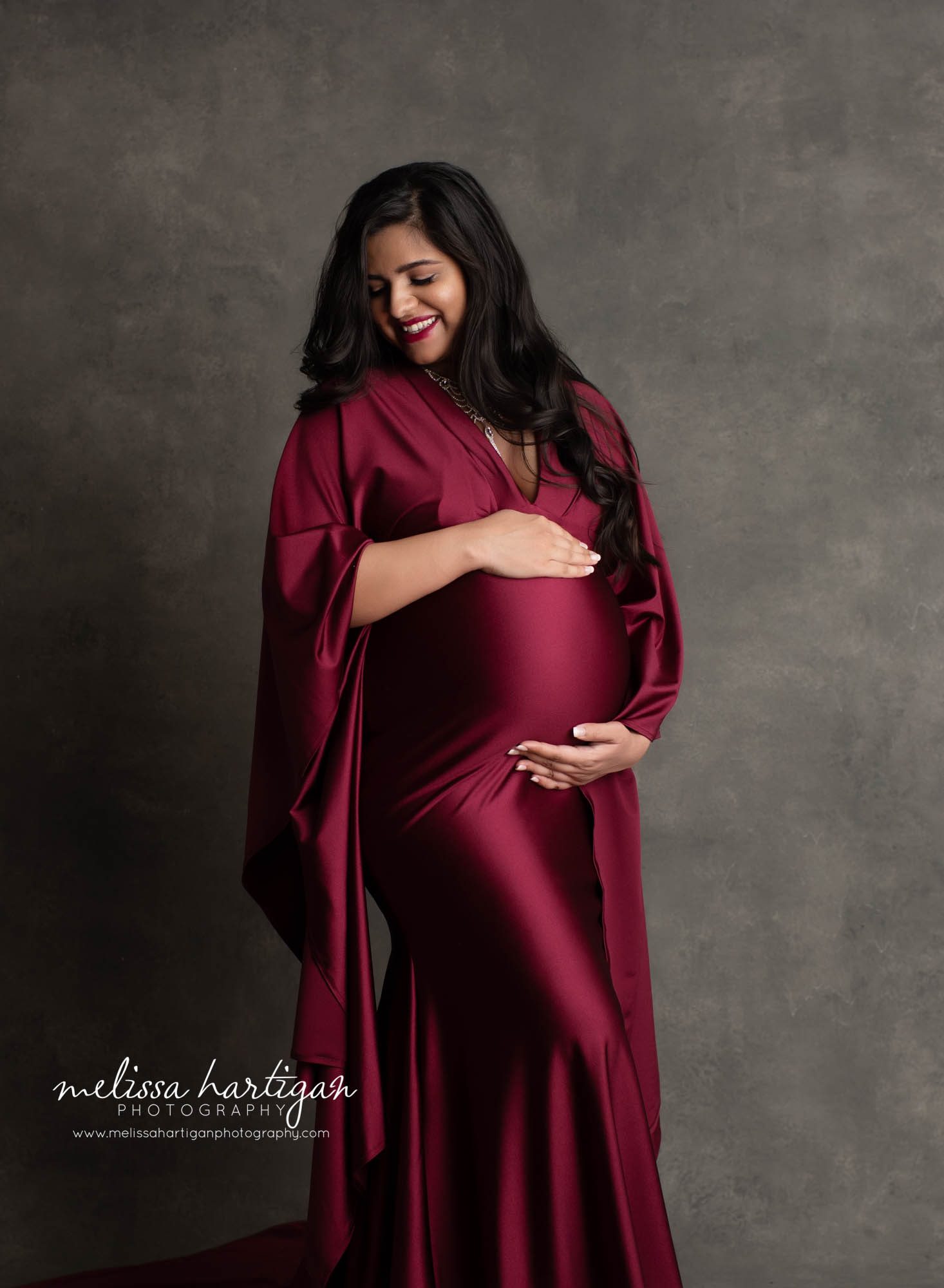 pregnancy studio picture mom happy holding baby bump maternity photographer manchester CT