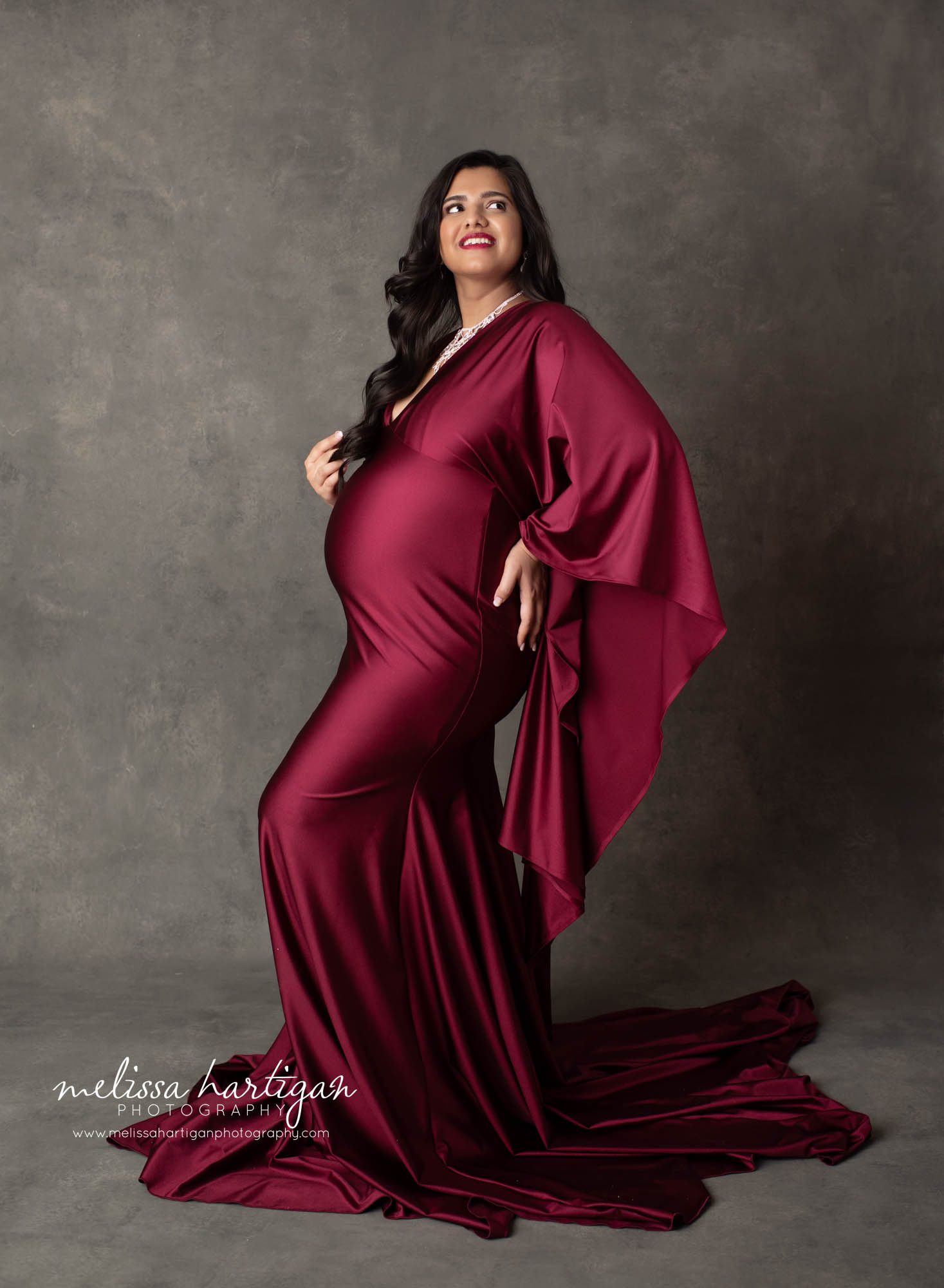pregnancy studio maternity picture mom holding backside showcasing baby bump maternity photography manchester CT