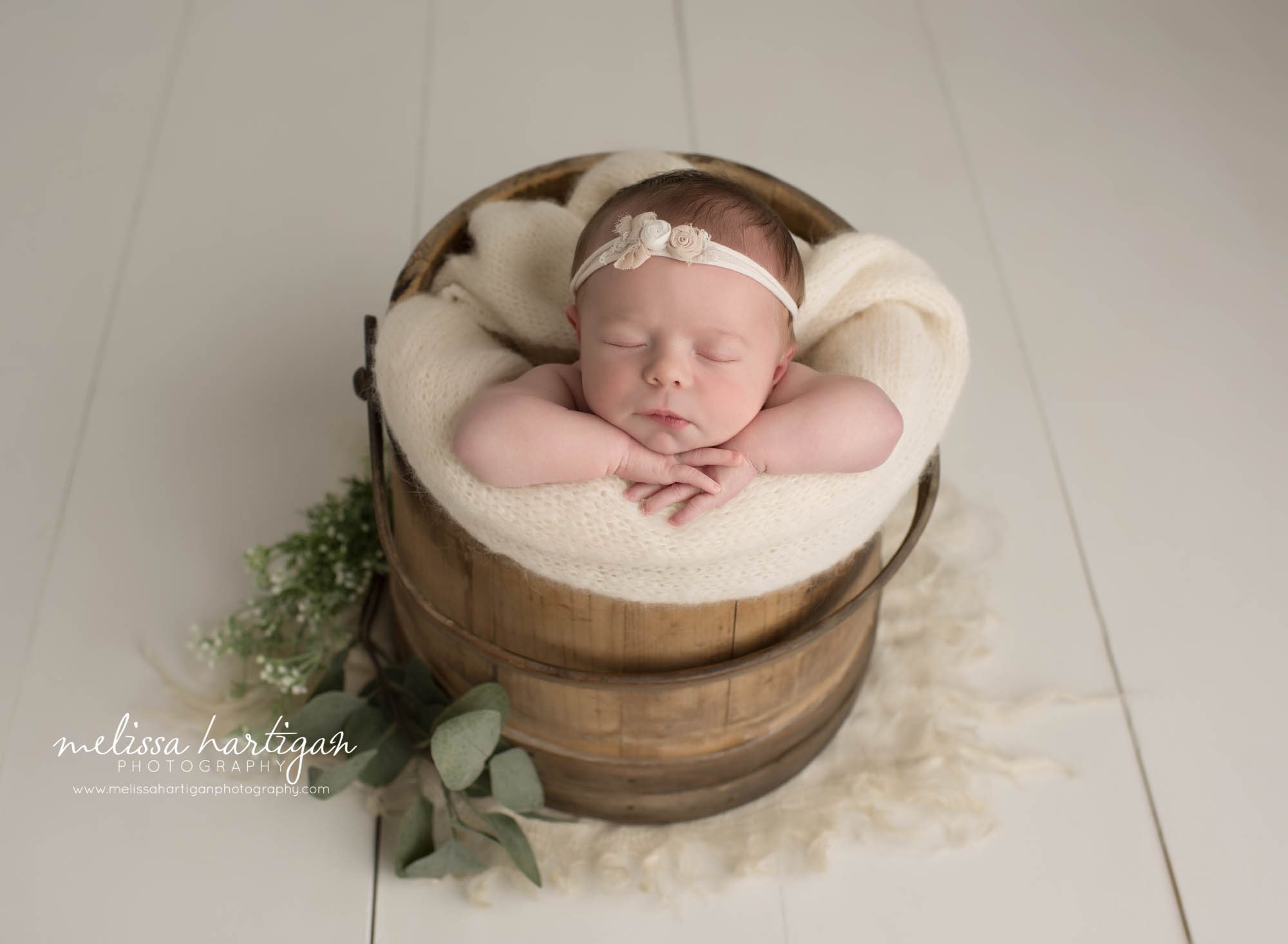 newborn baby girl posed in cream wrap in wooden bucket Newbonr london county CT newborn Photography