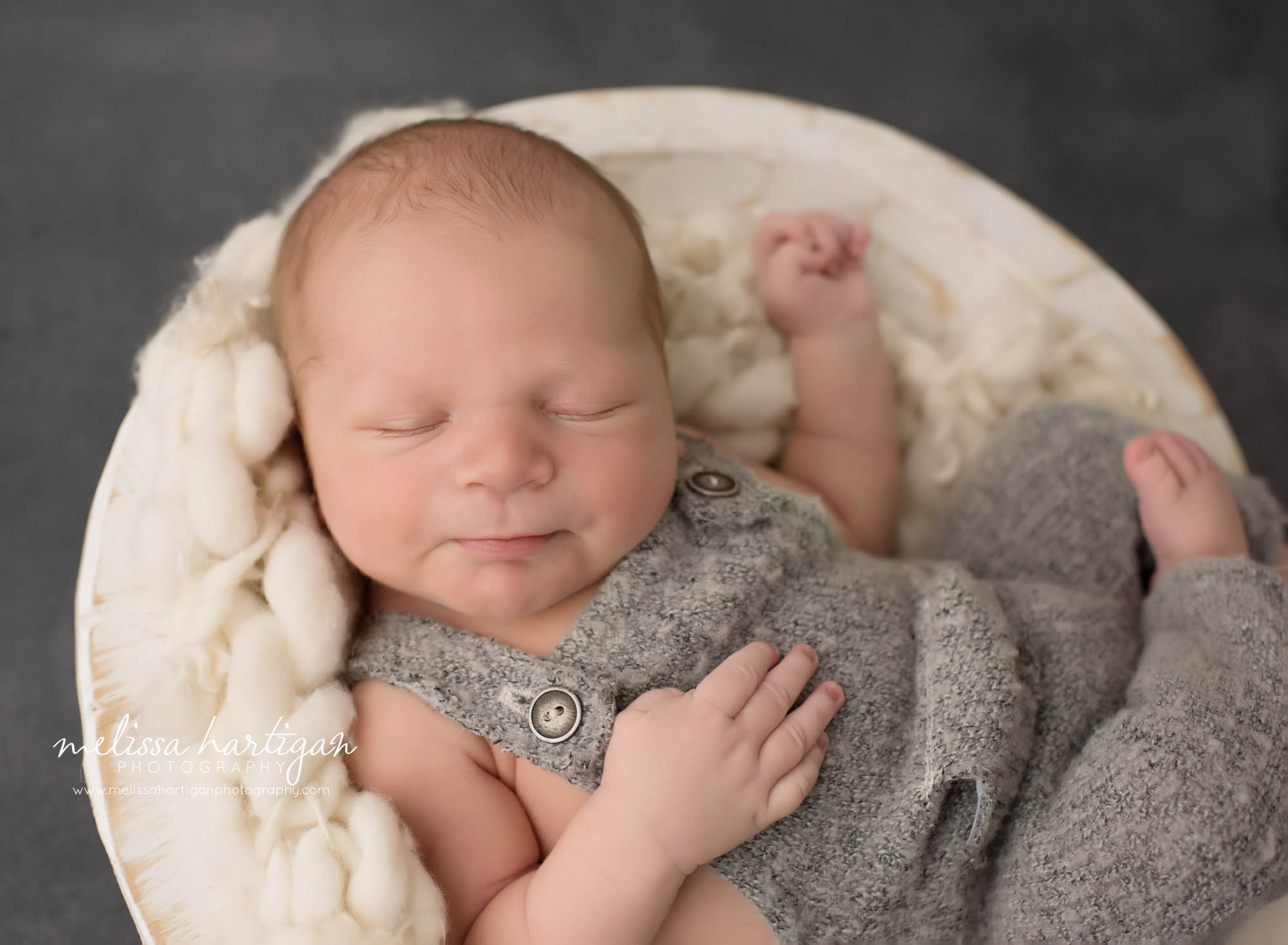 newborn baby boy posed in wooden bowl norwalk newborn photography