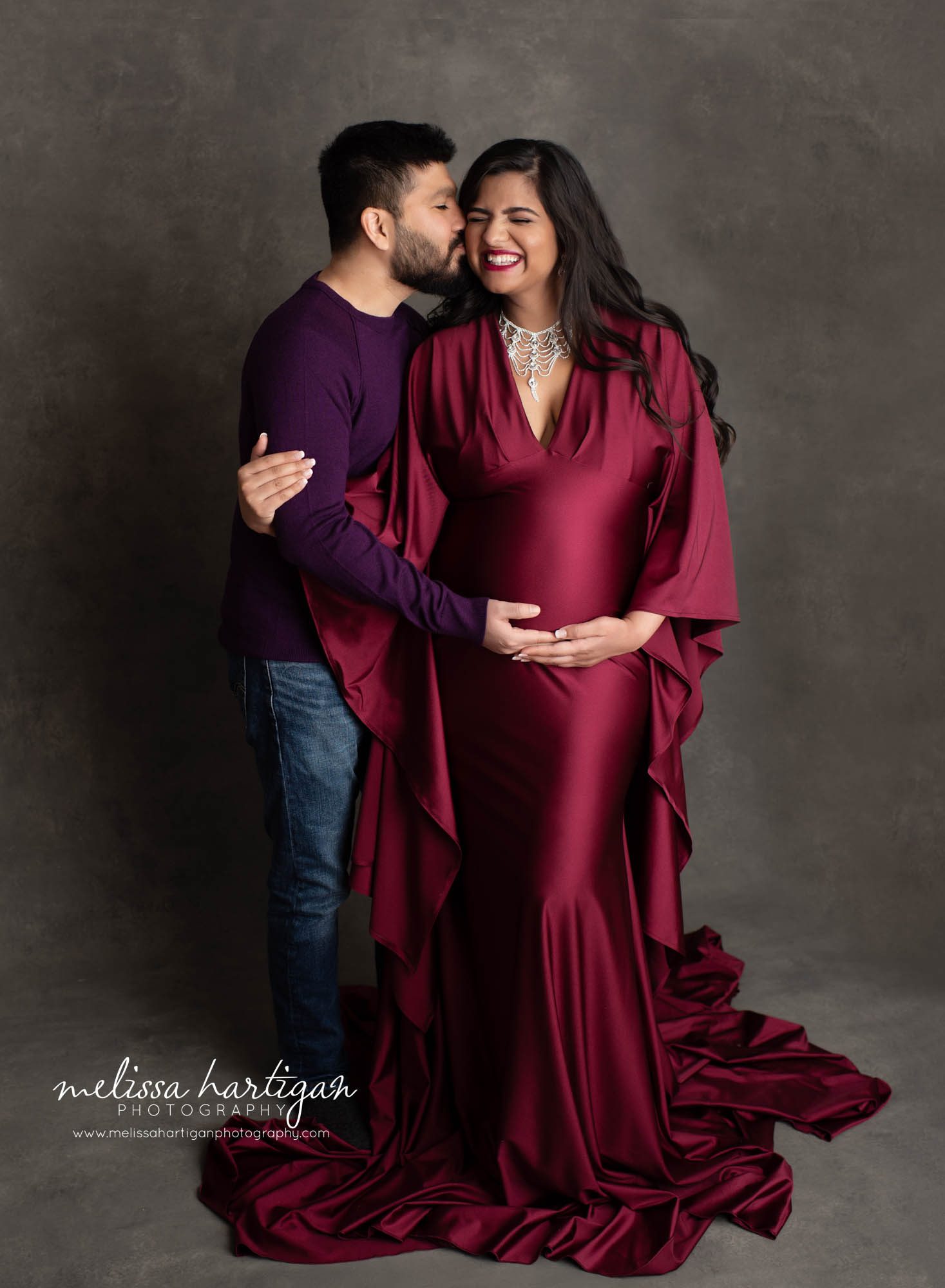 couples maternity picture happy laughing loving materntiy dress red satin silk long sleeves