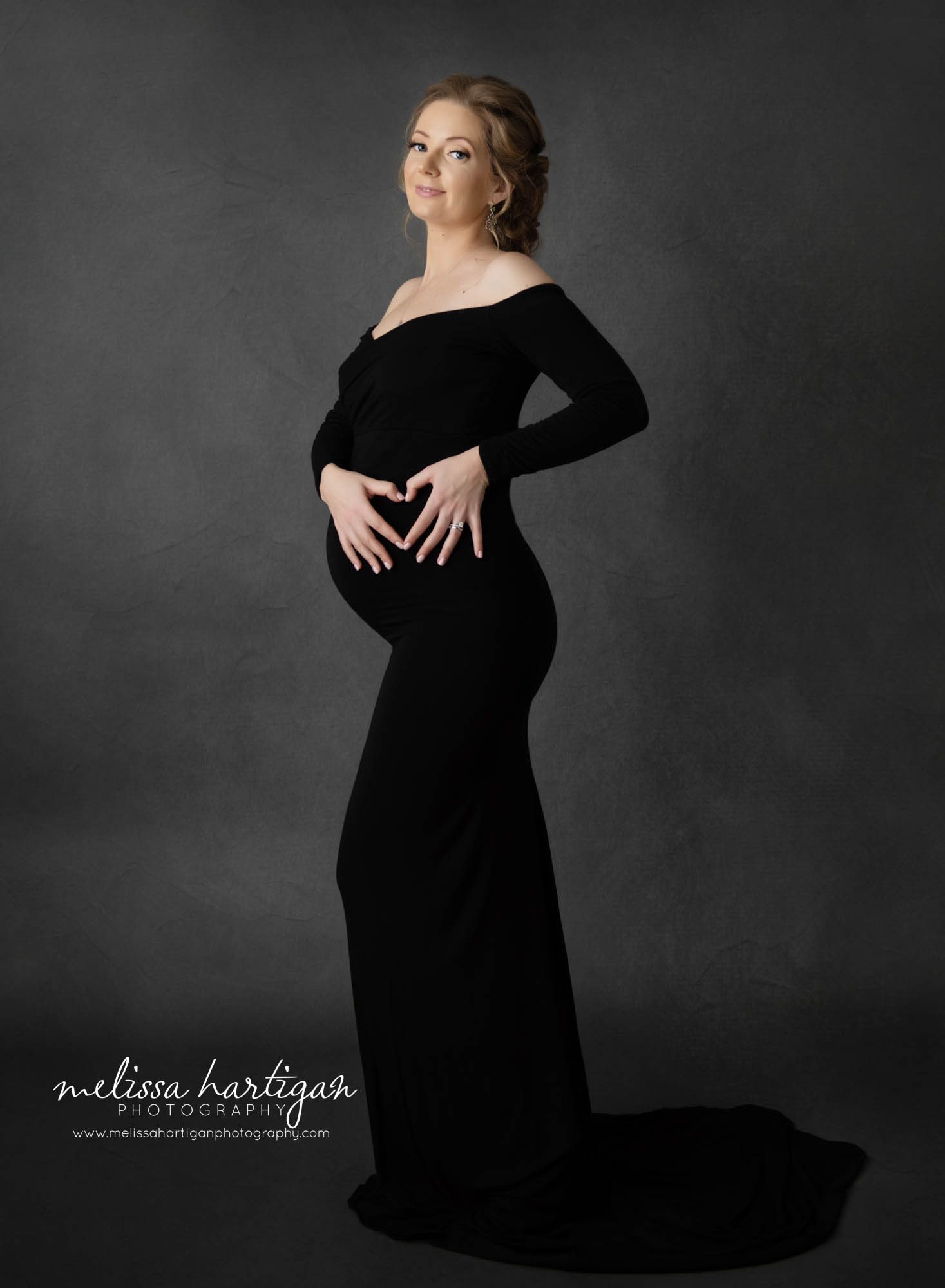mom to be hands on belly making hear with hands smiling west hartford pregnancy photographer