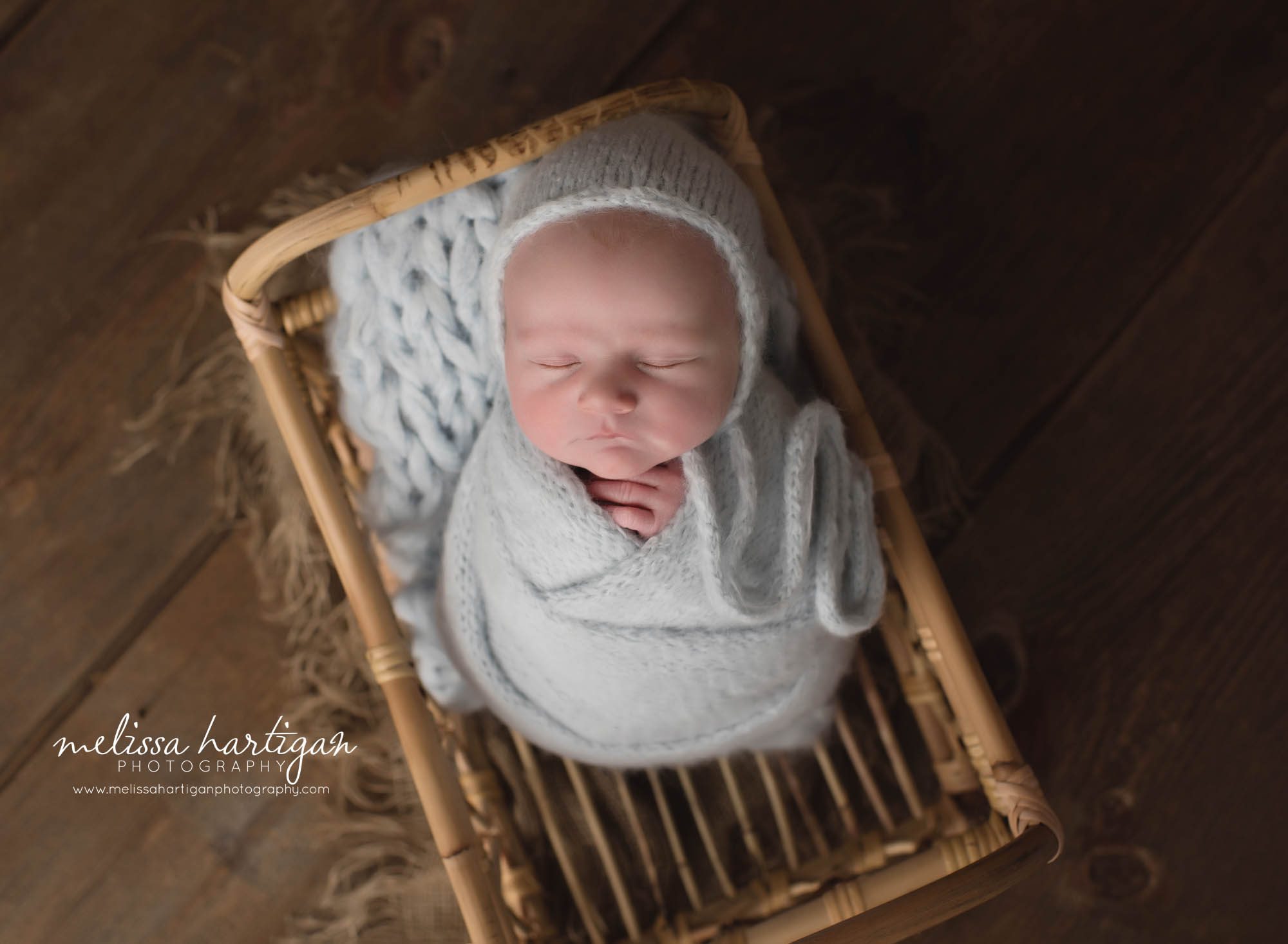 newborn baby boy wrapped in light soft blue knitted wrap and bonnet CT newborn photography