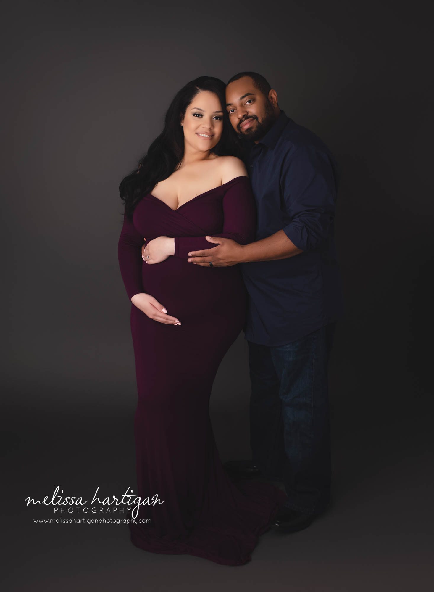 pregnant mom and dad holding baby bump studio maternity photography session