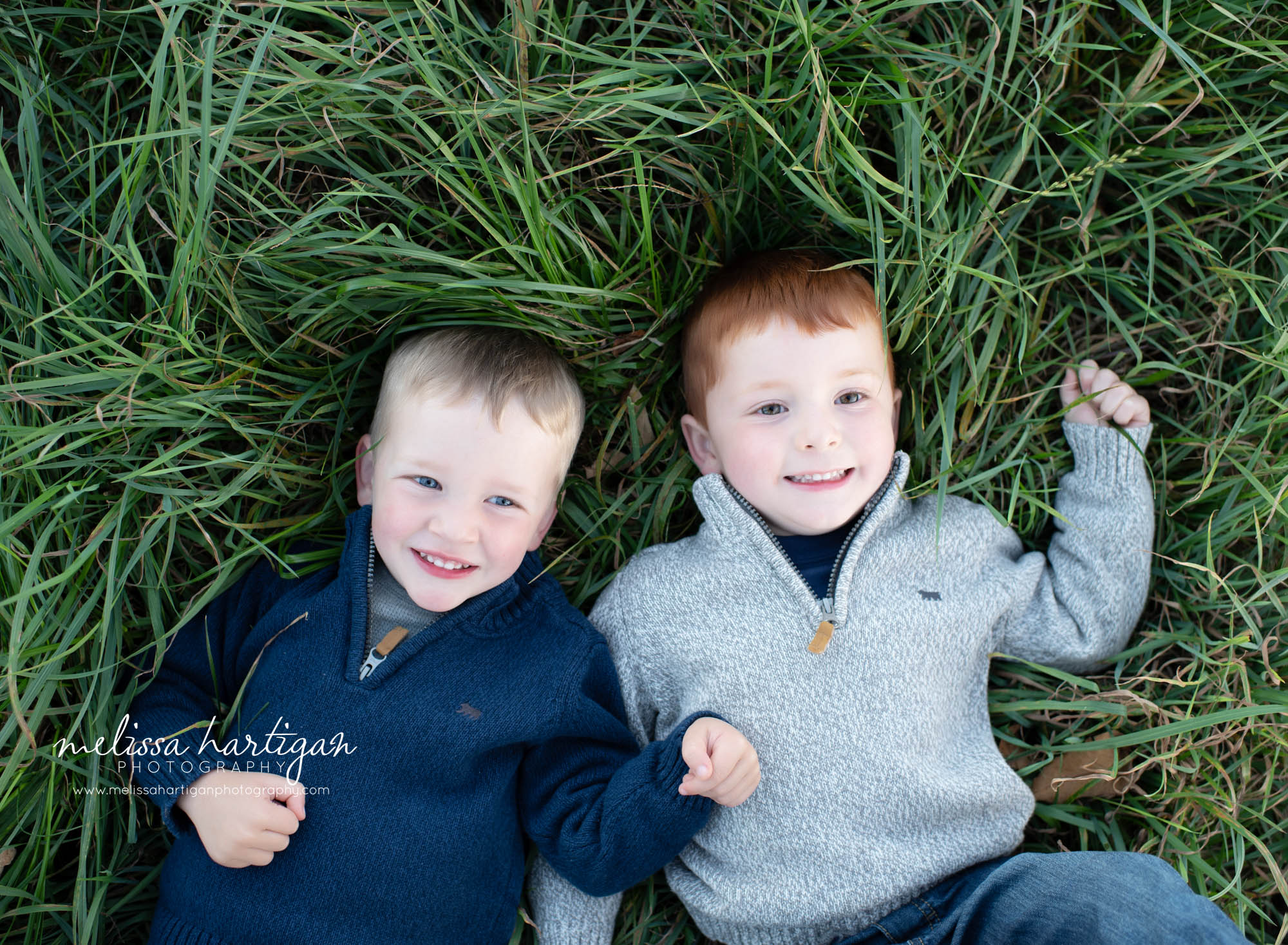 sibling brothers laying in the grass Ct family photography