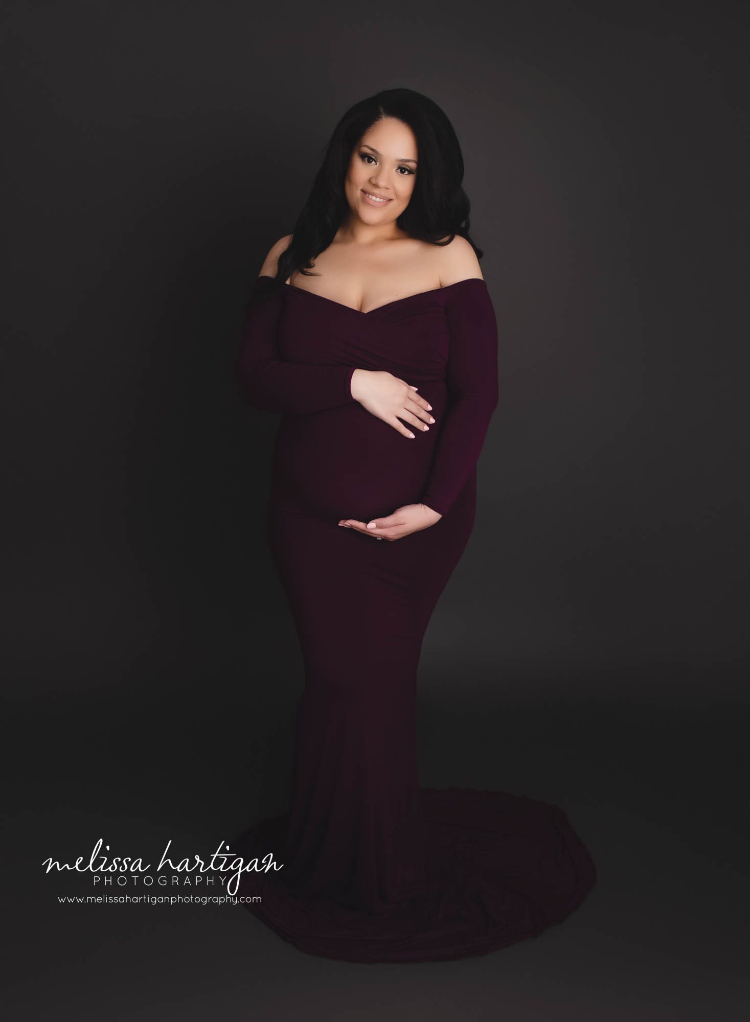 mom holding baby bump studio maternity photography session