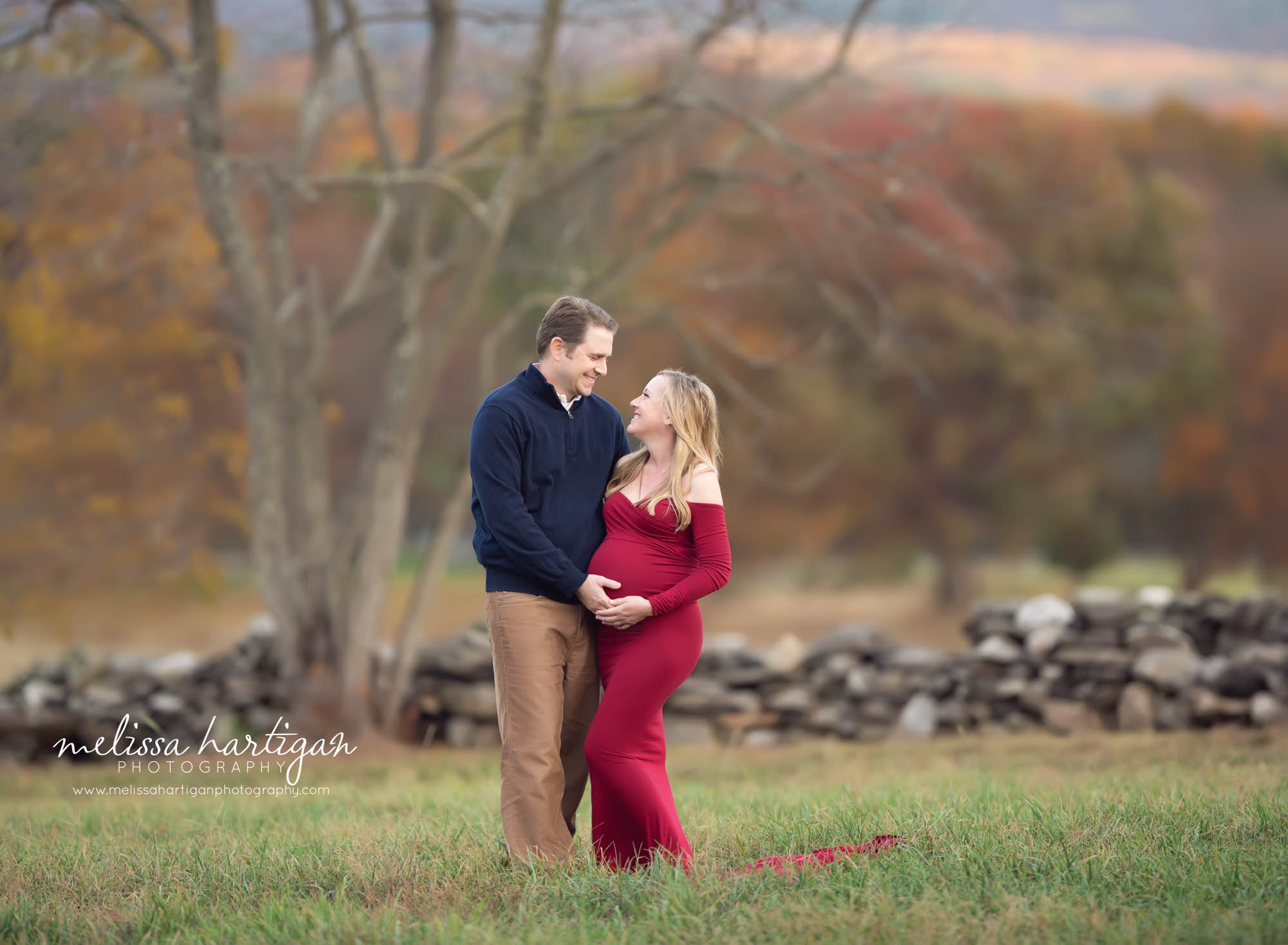 mom and dad to be handing baby bump looking at eachother laughing smiling. maternity newborn photography CT