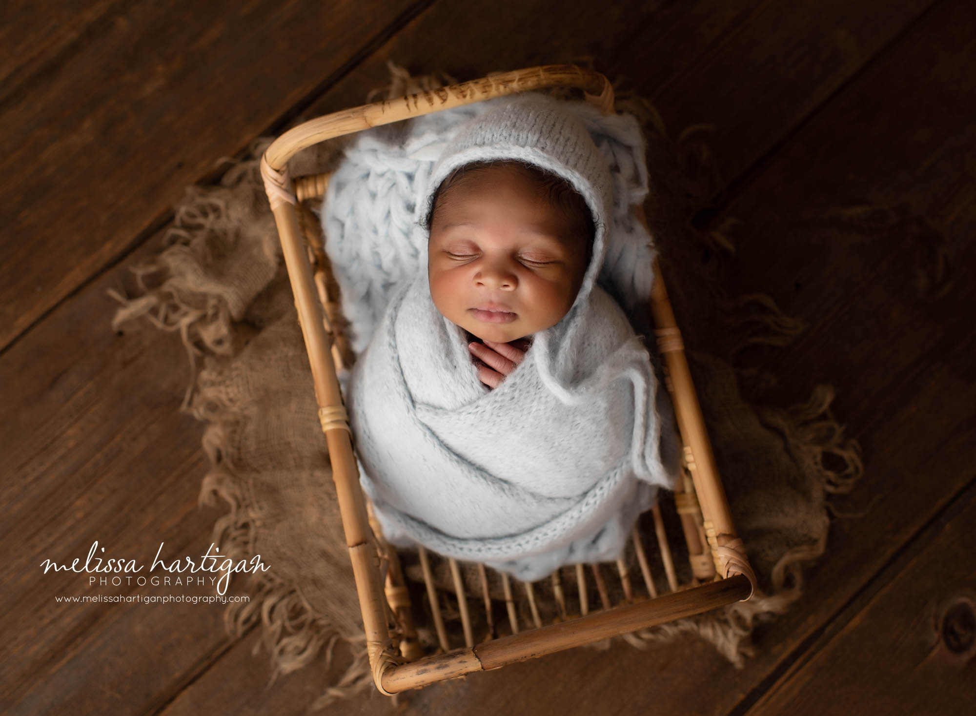 newborn baby boy wrapped in soft muted blue gray color with knitted bonnet newborn photographer CT