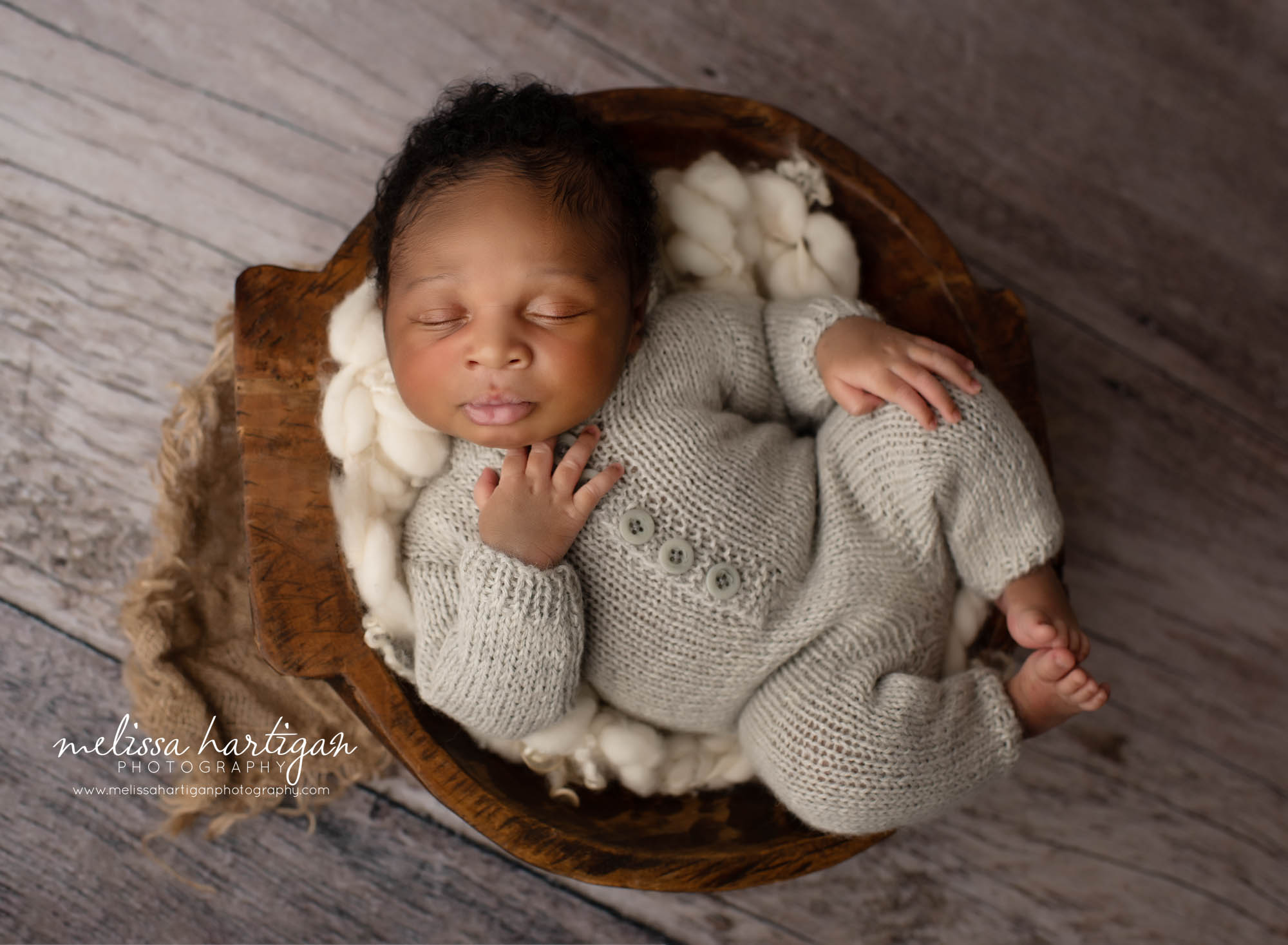 newborn baby boy wearing gray knitted outfit posed in wooden bowl newborn photography CT