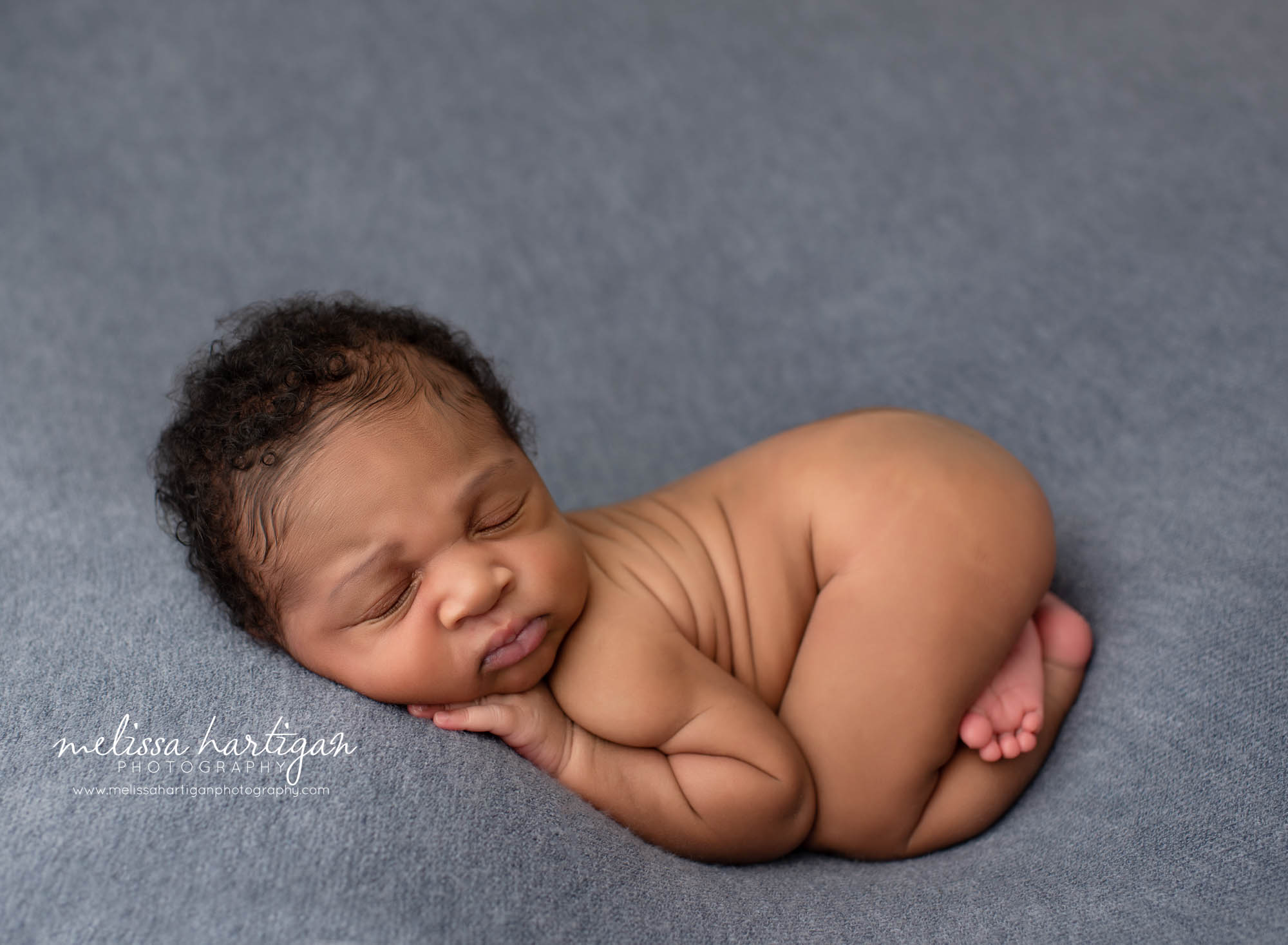 newborn baby posed on blue backdrop with bum up pose newborn photography Windsor