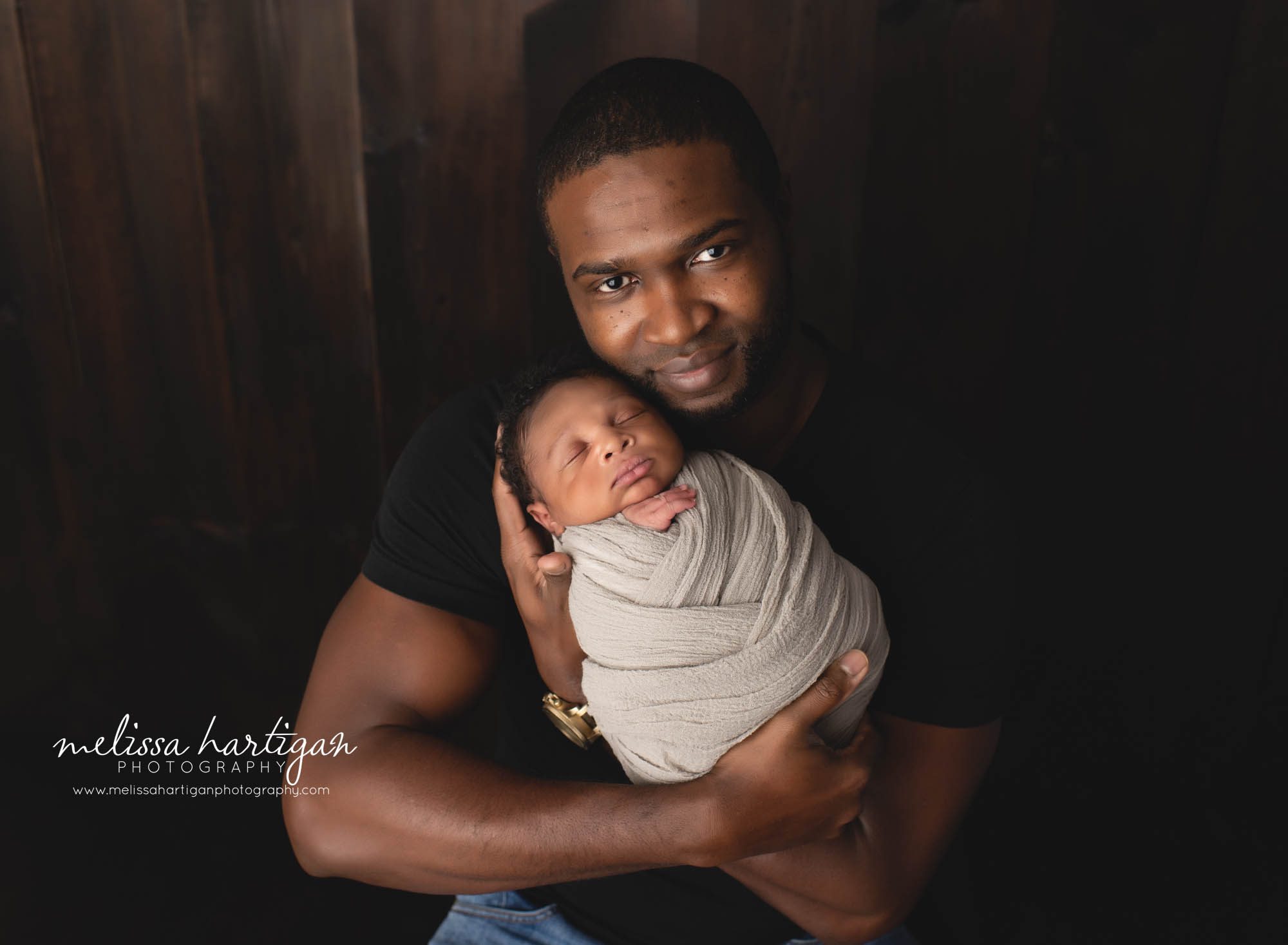 dad holding newborn son studio newborn photgraphy session windsor CT baby photography