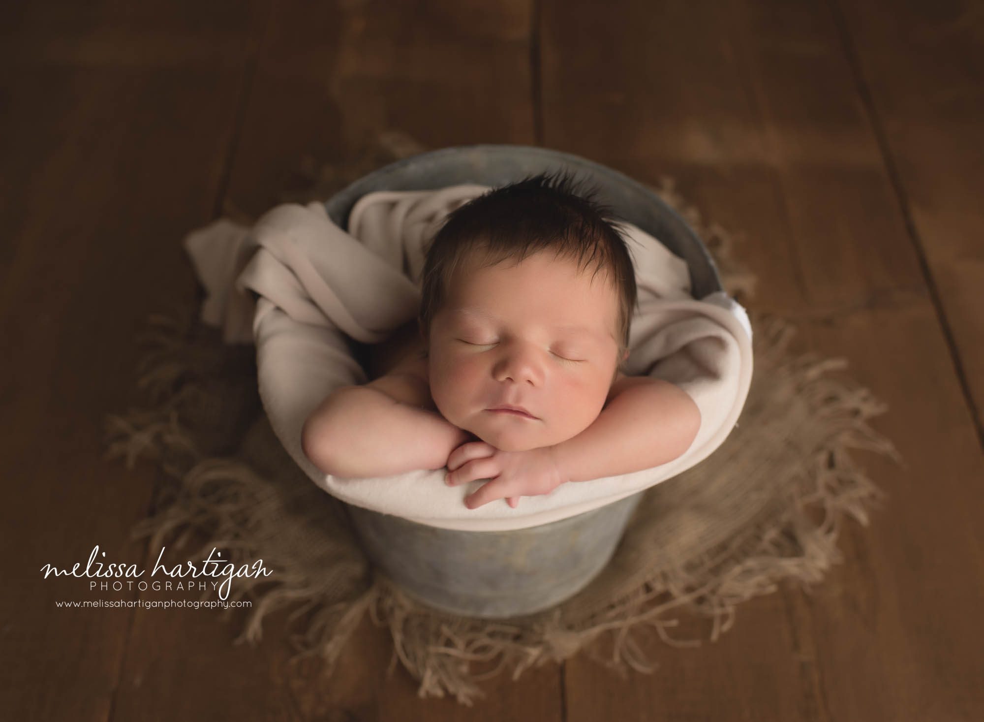 newborn baby boy posed bucket with cream layer CT glastonbury CT newborn photography