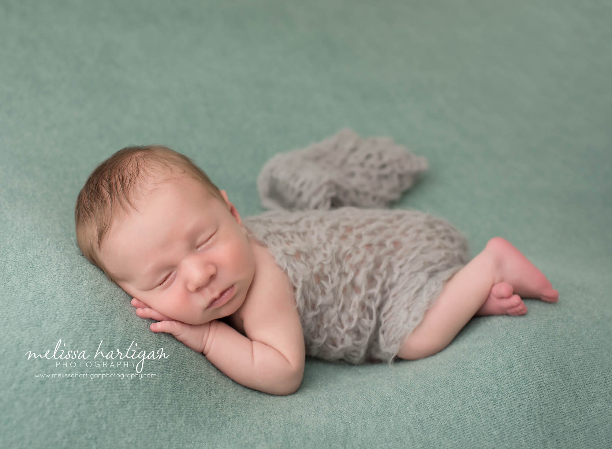 newborn baby boy posed on teal backdrop with light teal gray knitted layer CT newborn photography