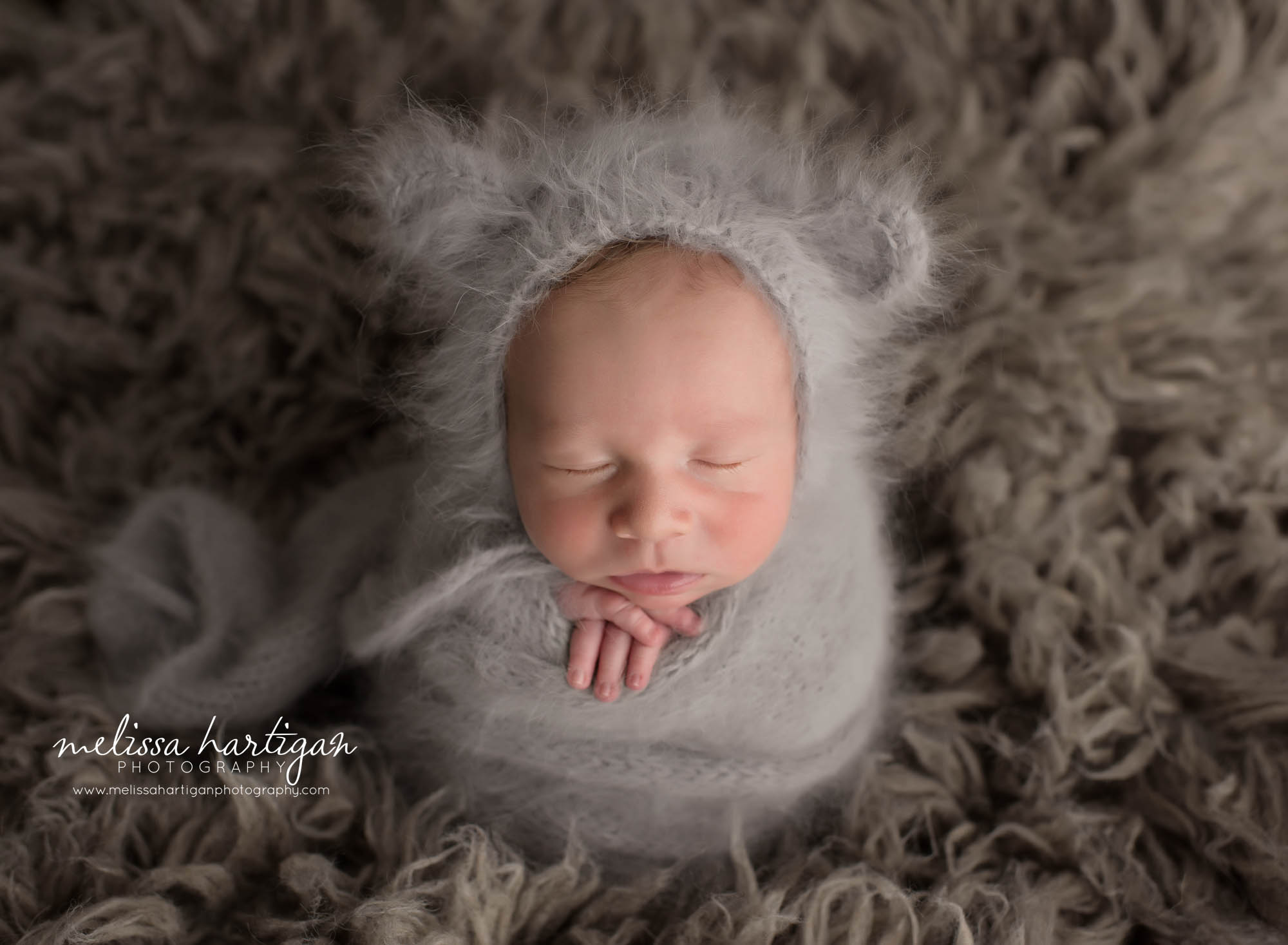 newborn baby boy wrapped in light gray knitted wrap with teddy bonnet CT newborn Photographer