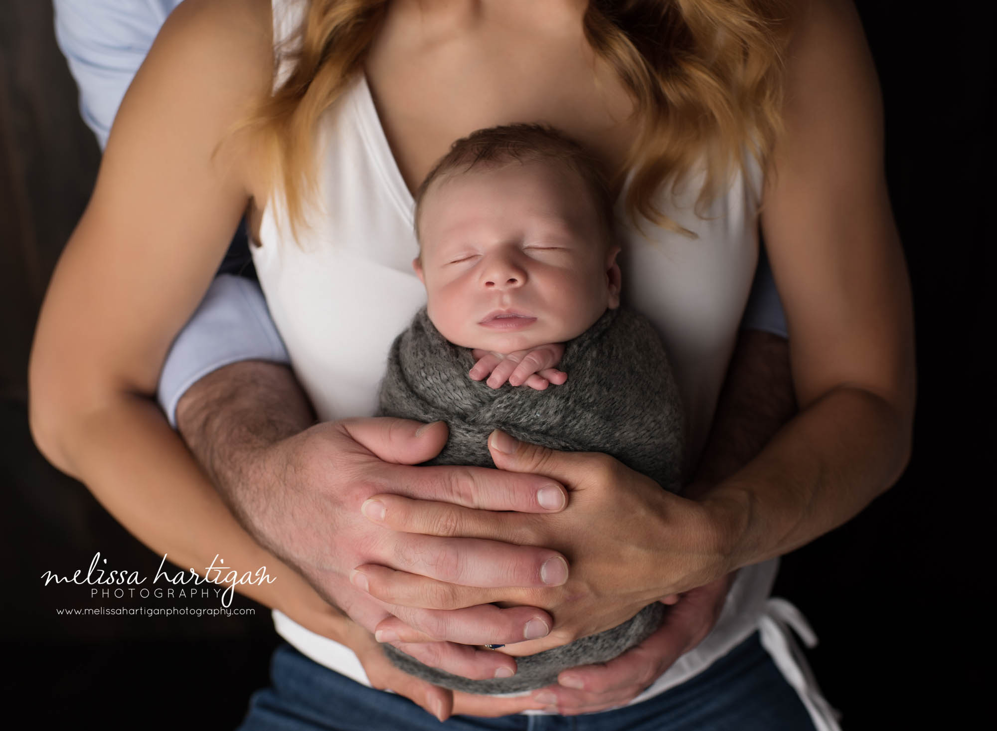 mom and dad holding newborn son in family pose CT newborn Photography