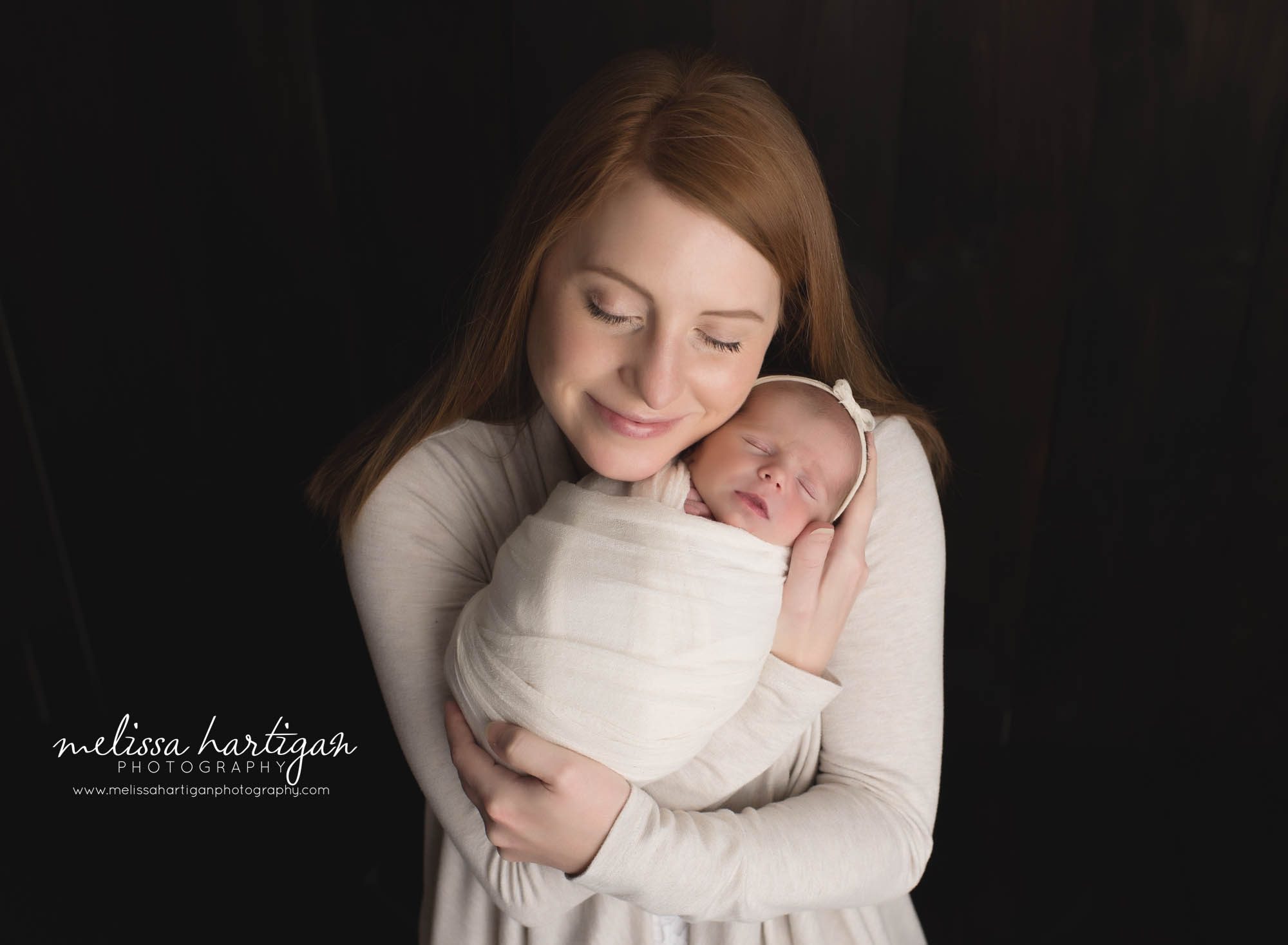 mom holding newborn daughter parent pose studio newborn photography session coventry CT