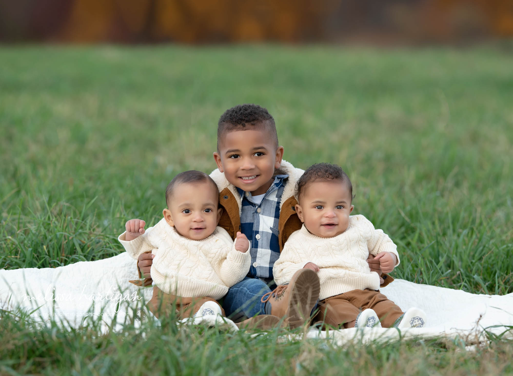 three children three siblings sitting on blanket outside family photography CT