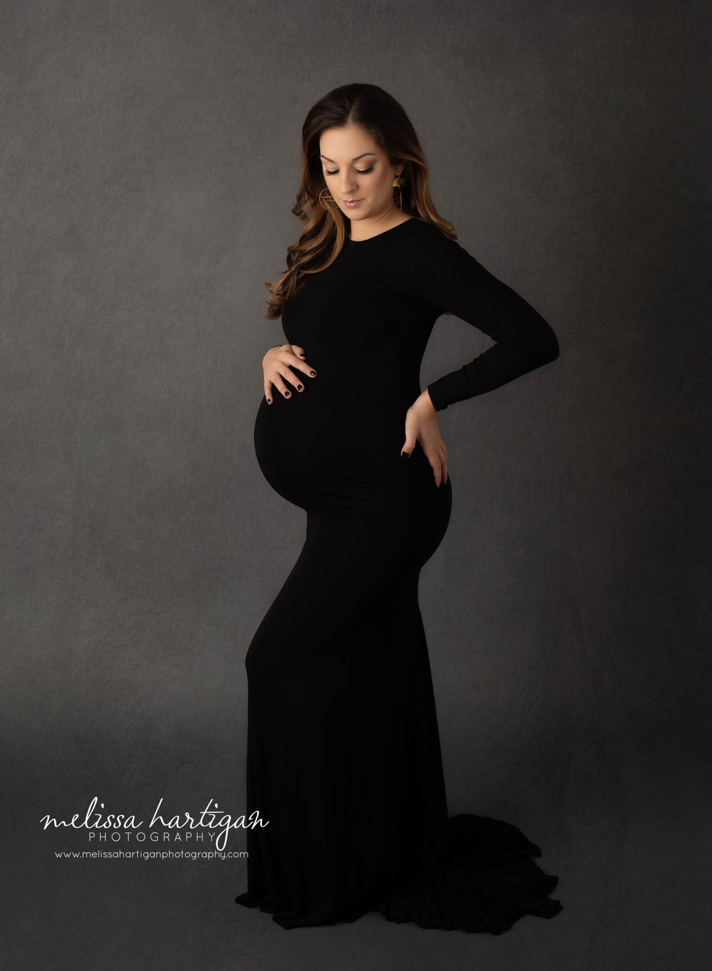 pregnant mom wearing black long form fitted maternity gown with sleeves hartford county maternity photography