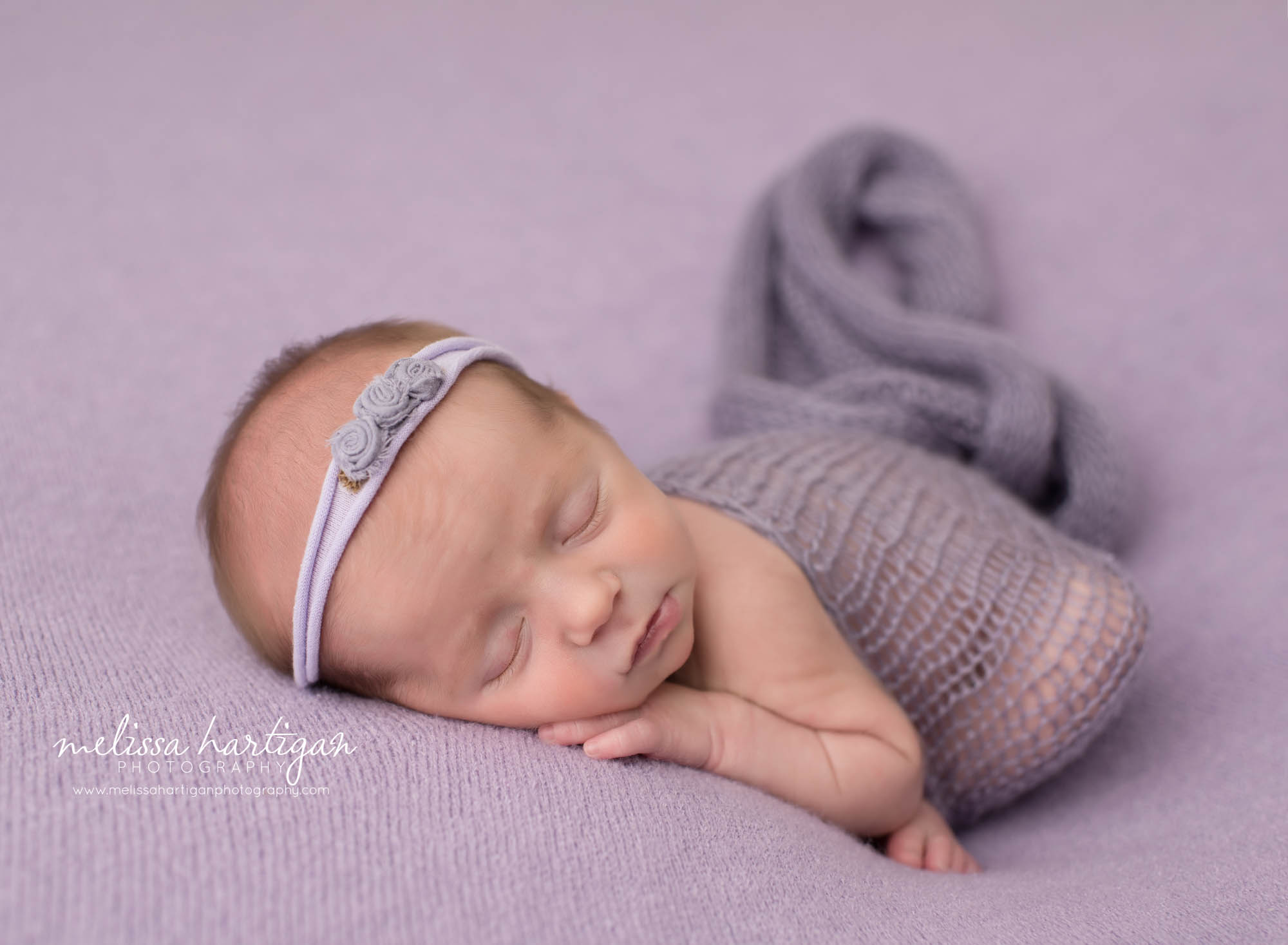 newborn baby girl posed modified taco pose newborn photography with knit light purple wrap and flower rose bud headband newborn photographer coventry