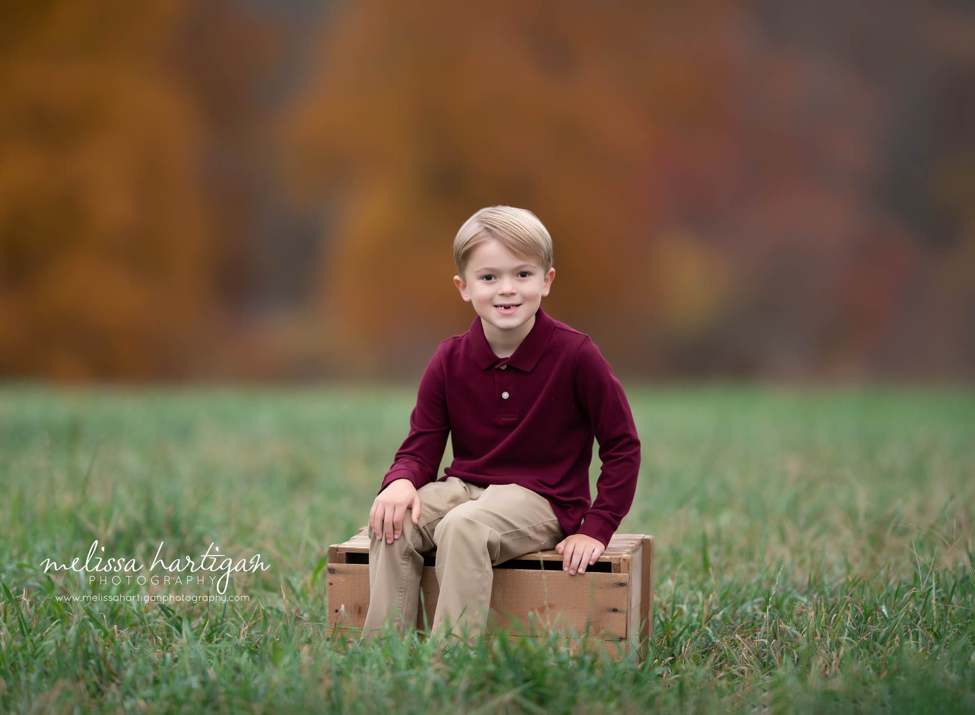boy sitting on create in field family photo session CT photographer