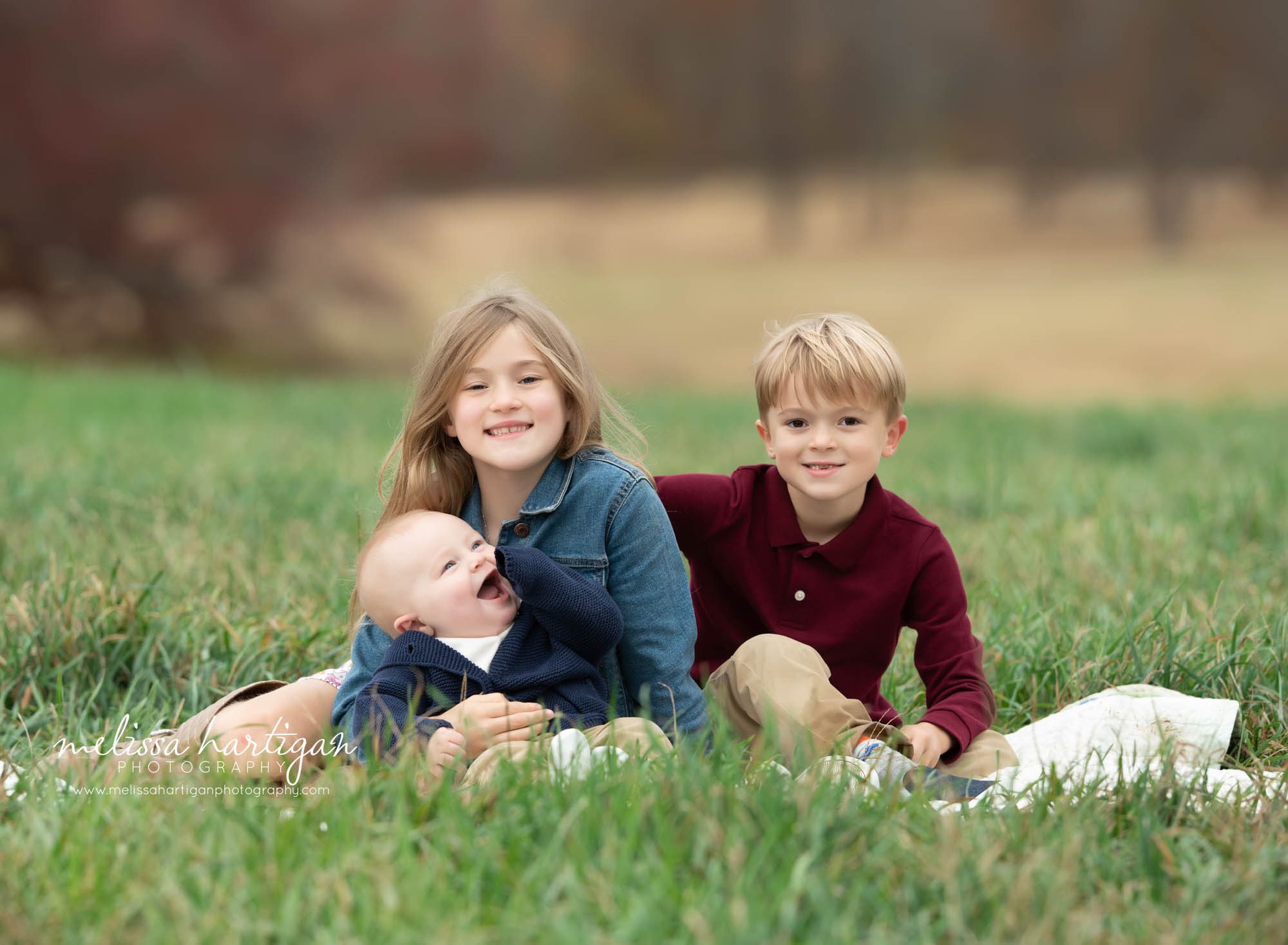 big sister big brother baby brother sitting on blanket family photography tolland CT