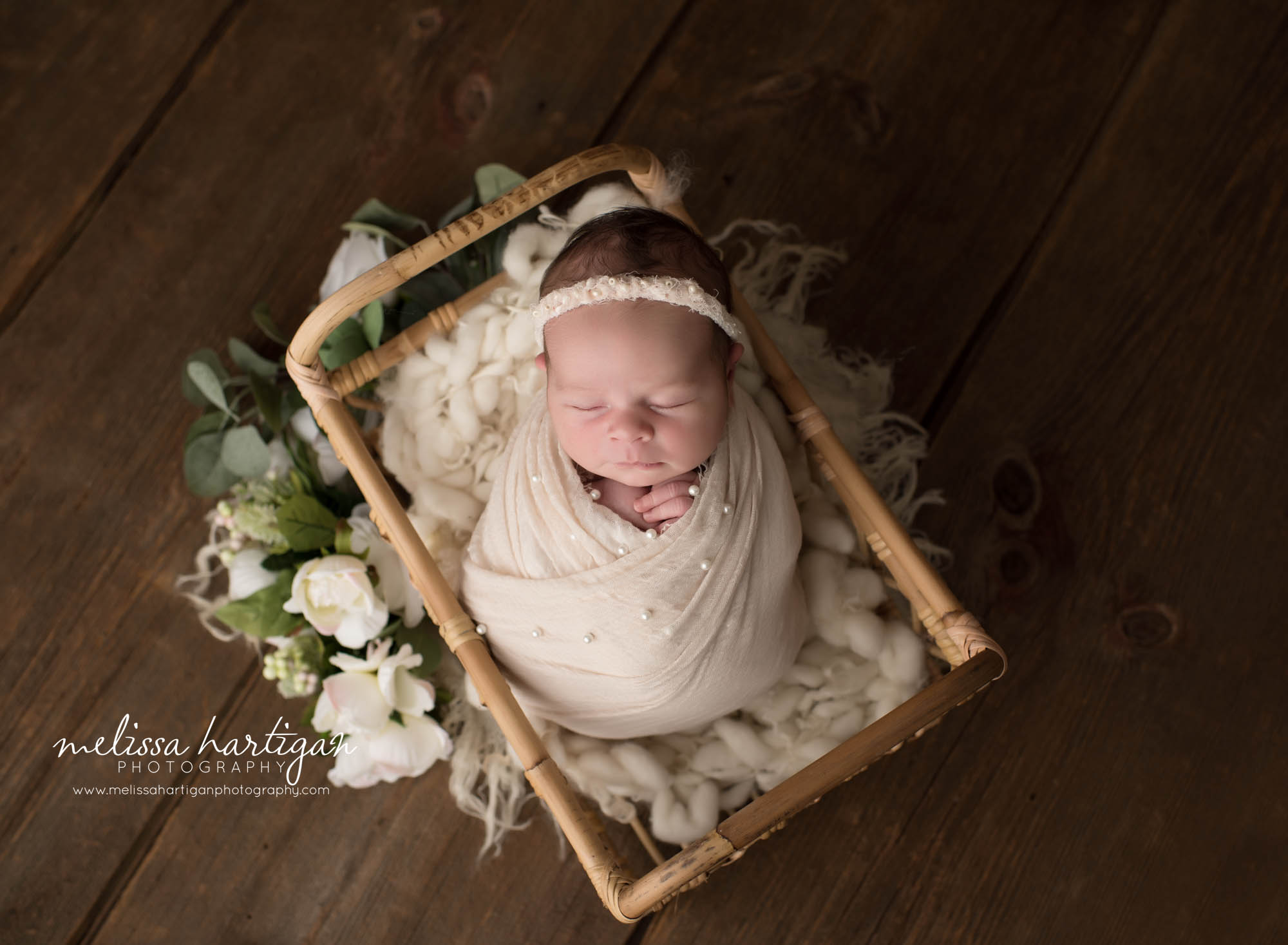 newborn baby girl wrapped in beige wrap with beige pearl headband hartford county newborn photography