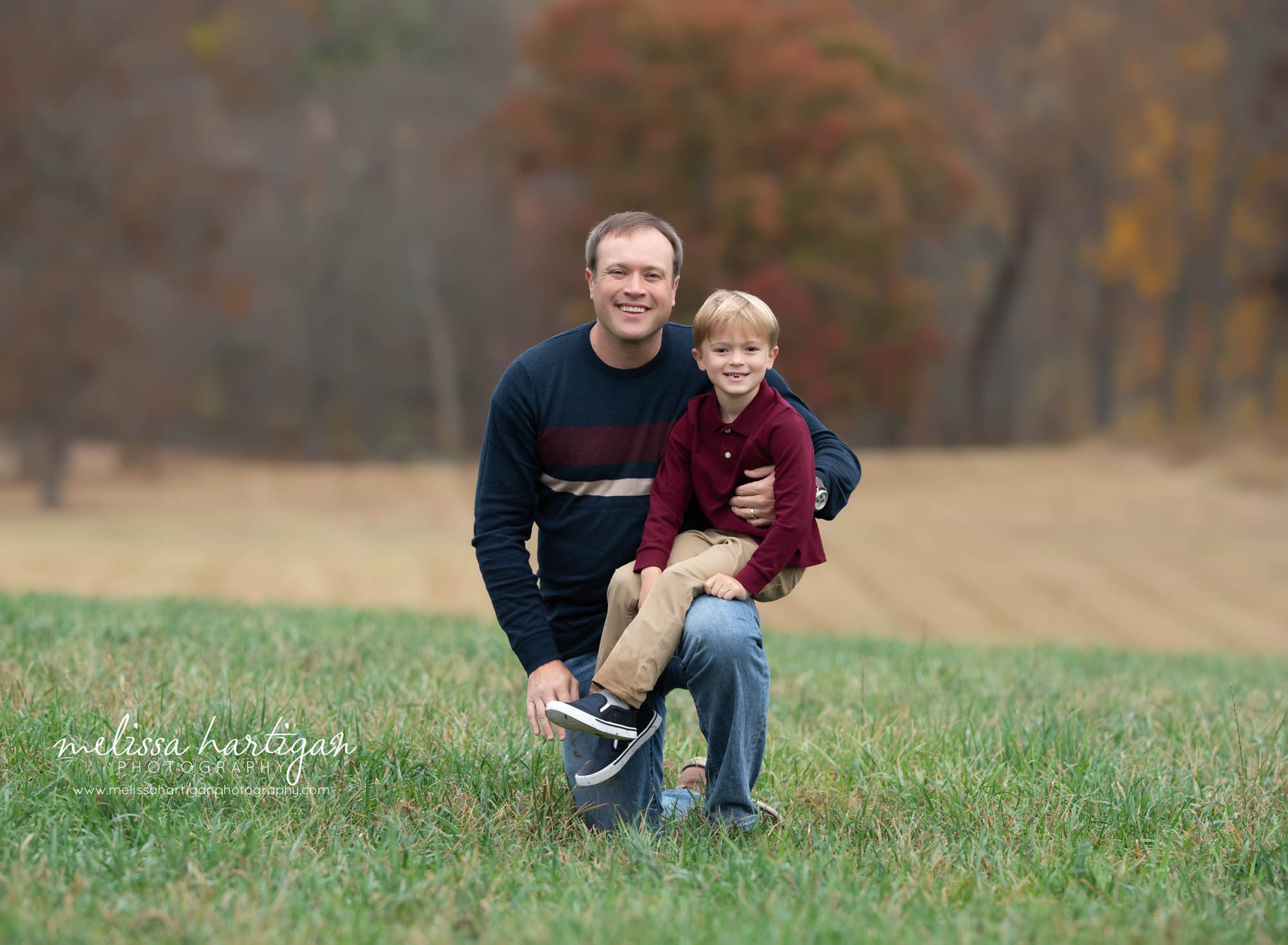 dad with son kneeling family picture pose