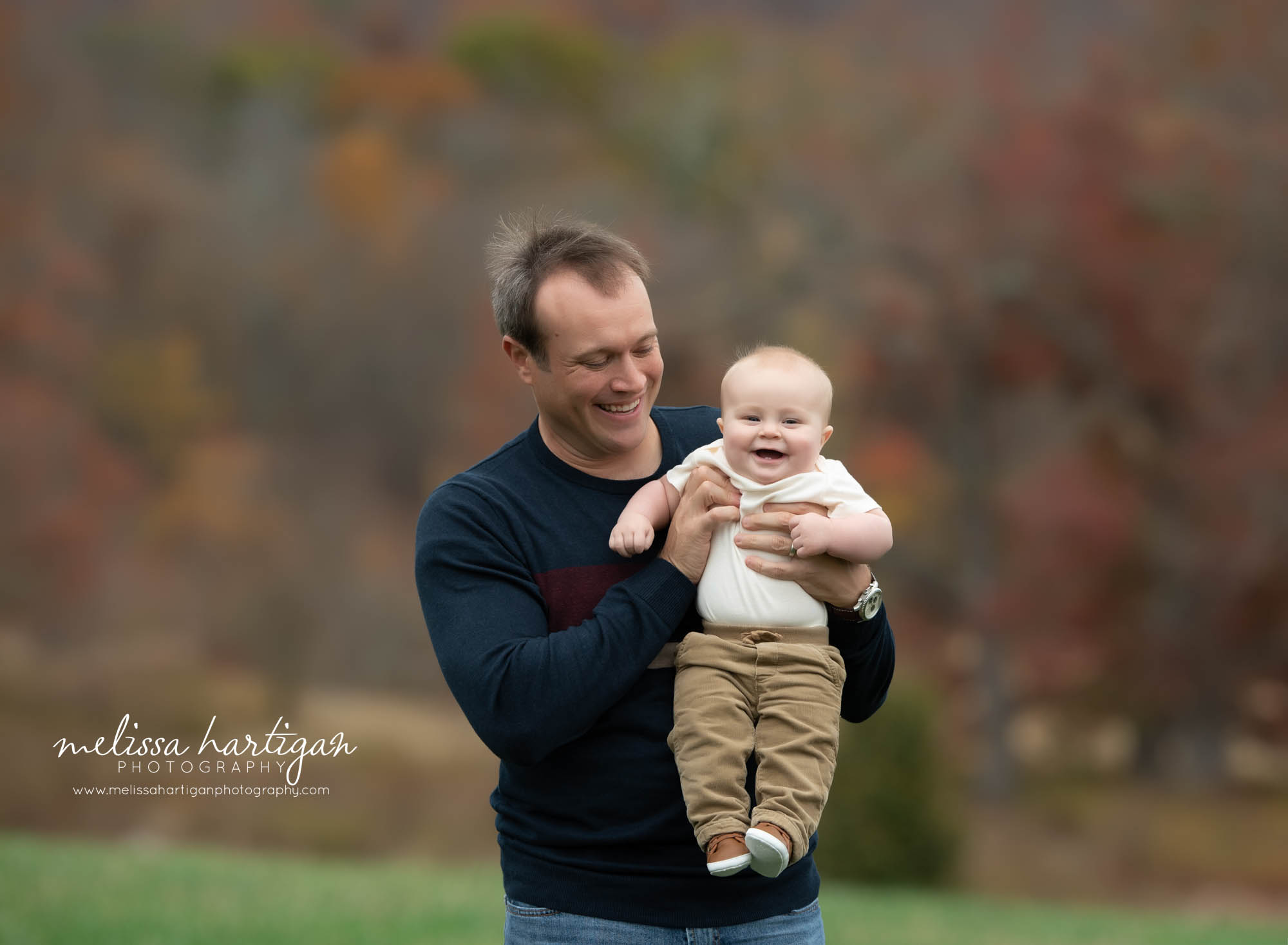 dad holding baby son laughing smiling tolland CT family photographer