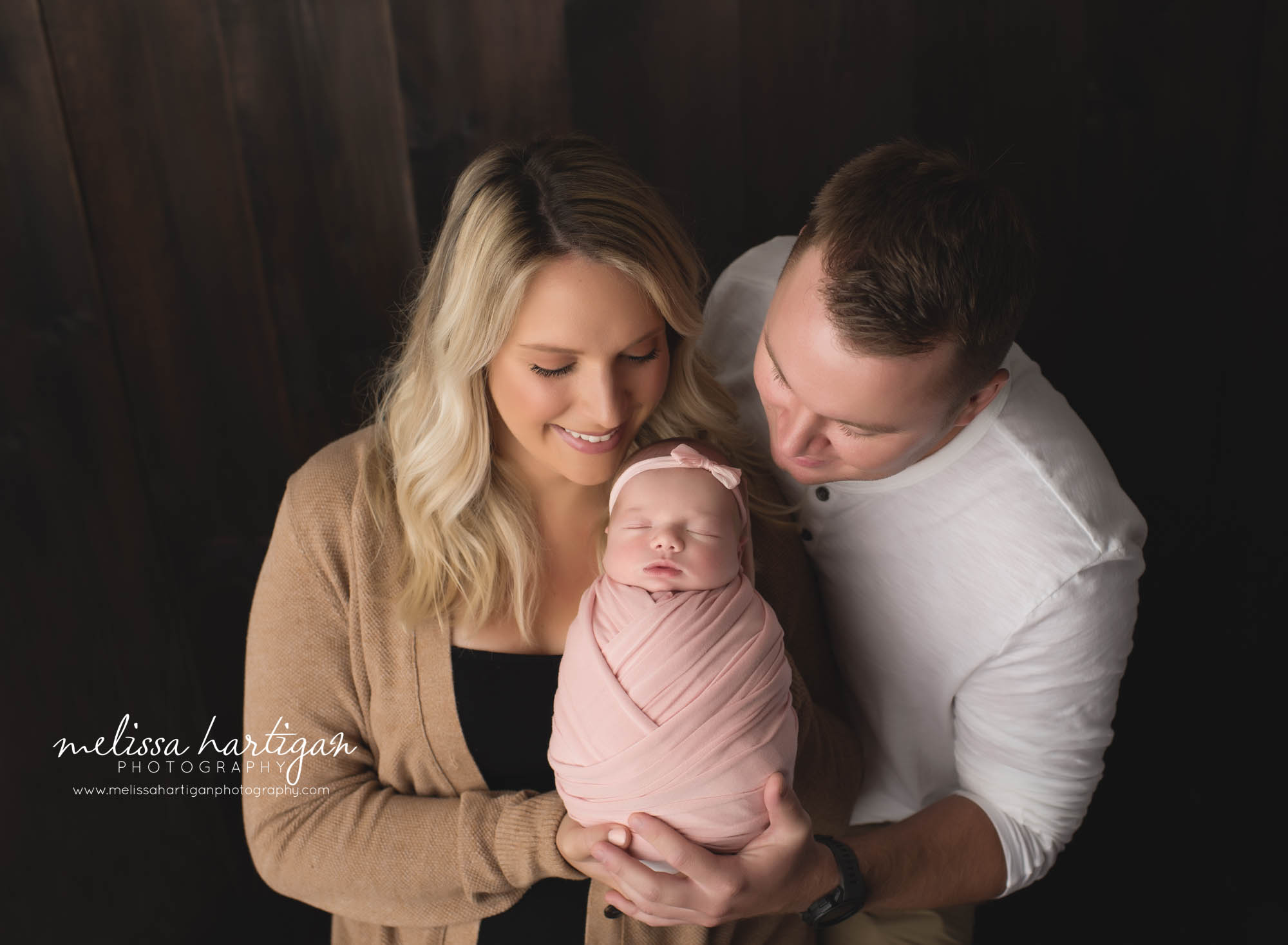 mom dad newborn baby daughter wrapped up family pose newborn photography CT