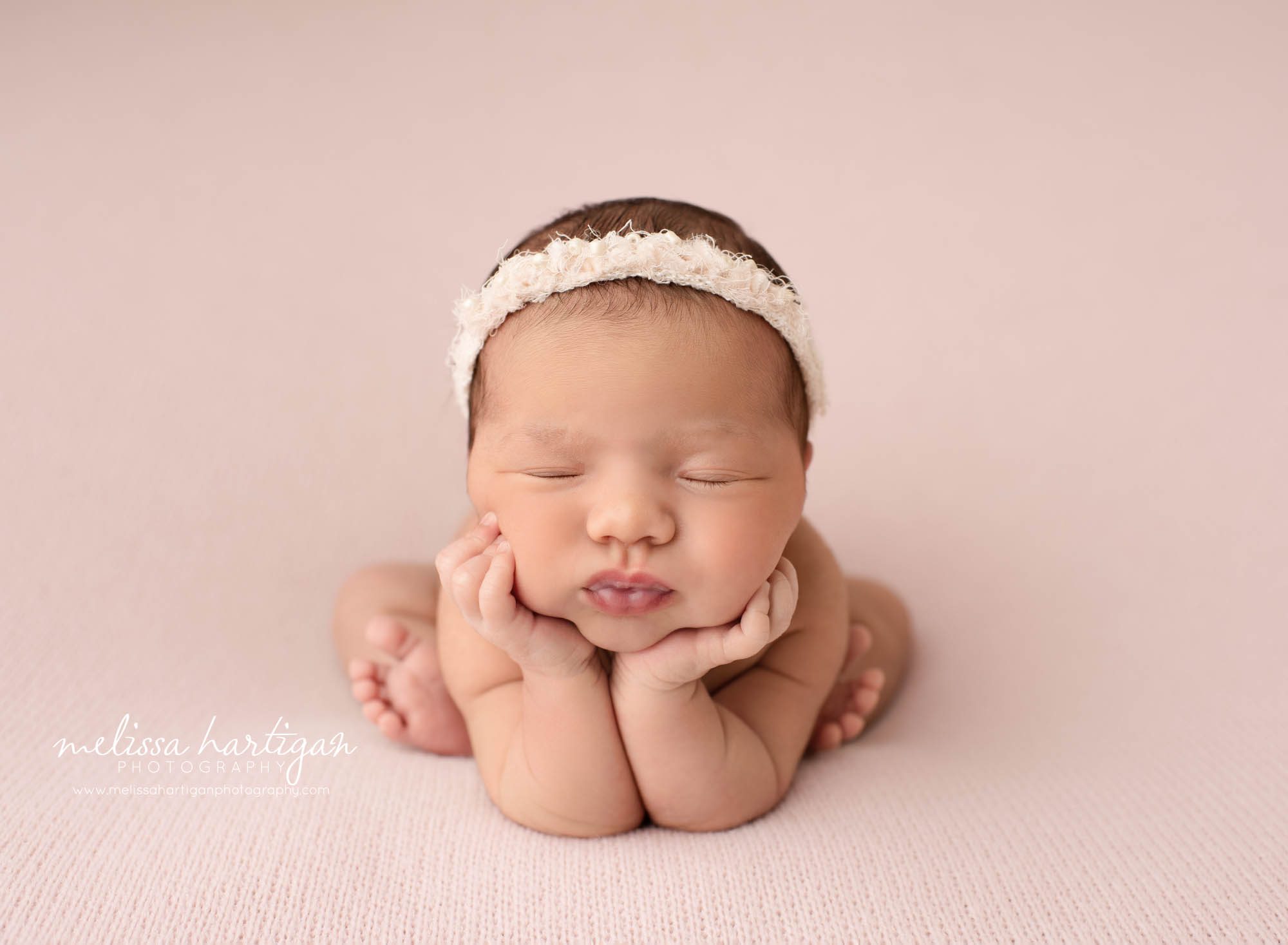 newborn baby girl posed froggy pose with puckered lips east hartford baby photographer
