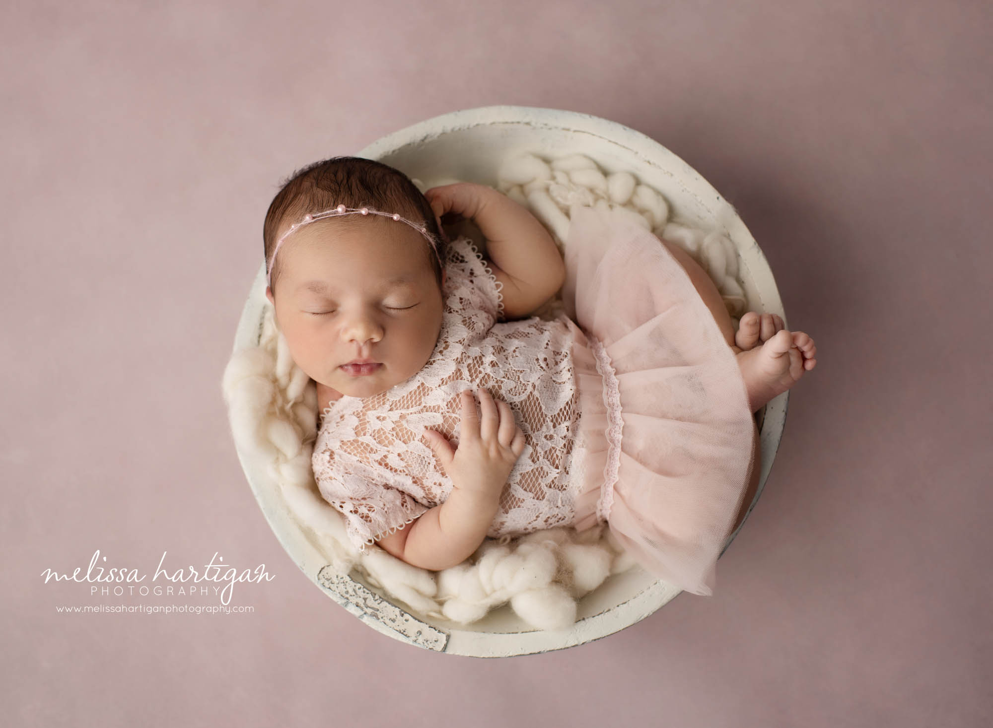 newborn baby girl wearing lace and pink newborn outfit with beaded headband east hartford baby photographer