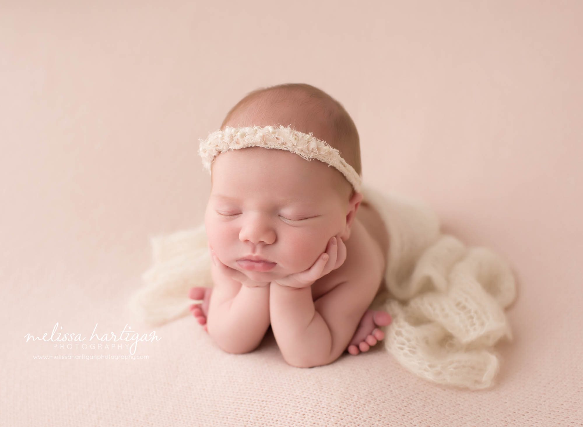 newborn baby girl posed froggy psoe to the side