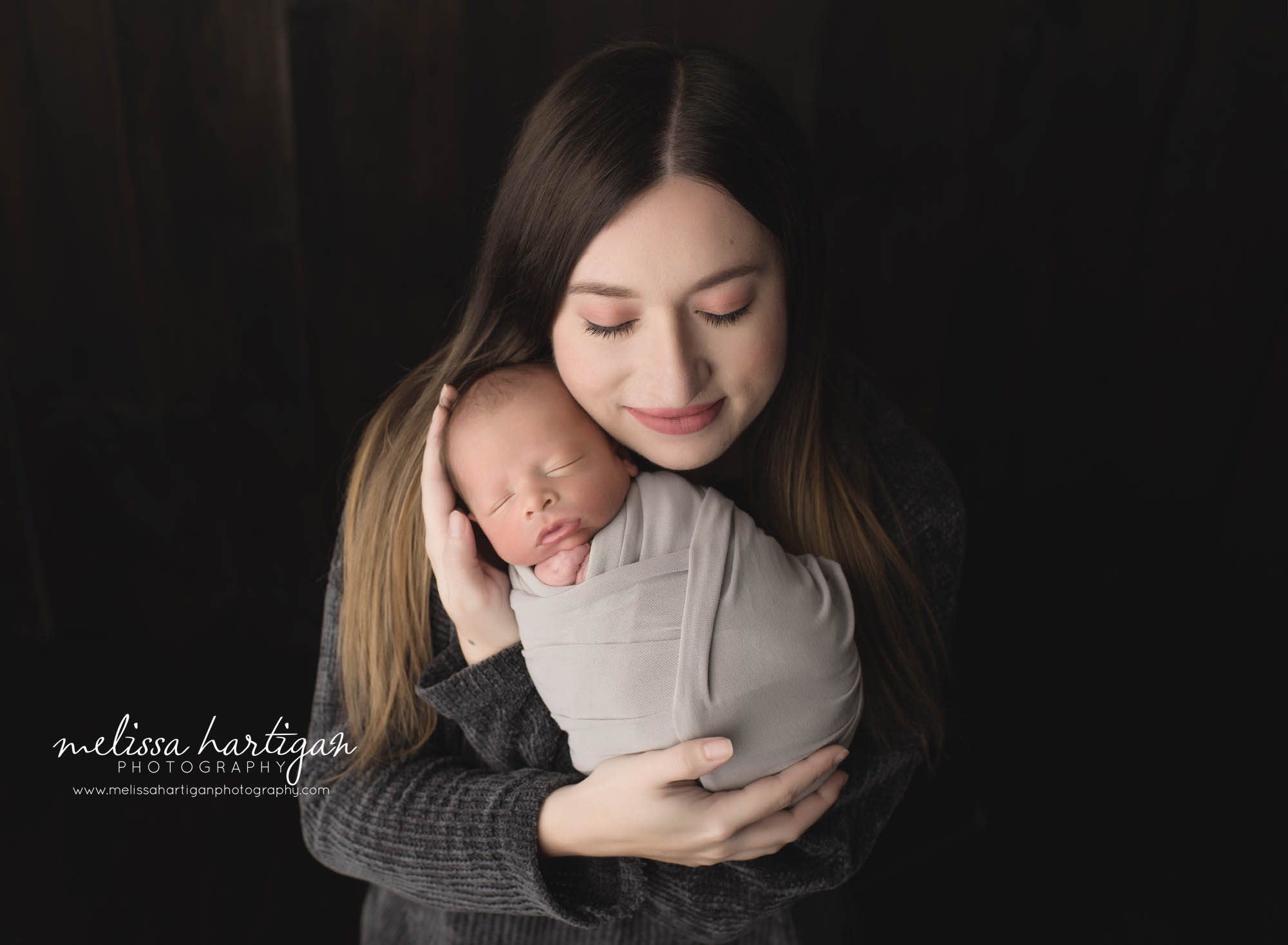 mom holding newborn son in mother son pose newborn photography CT