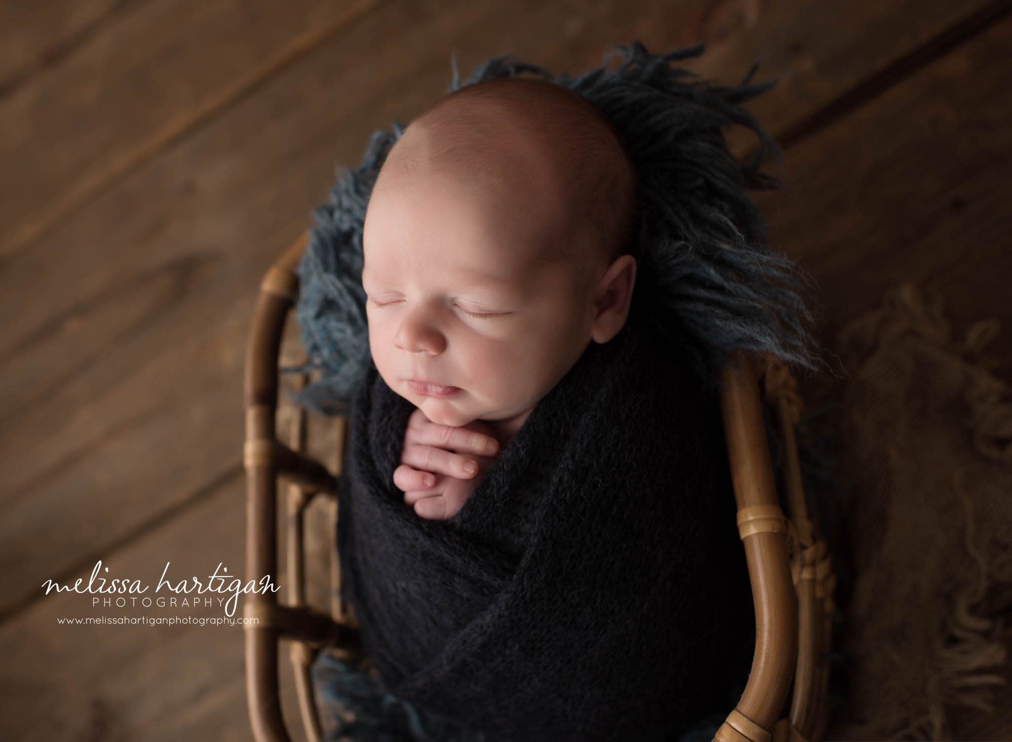newborn baby boy wrapped in dark navy blue wrap Newborn photography CT