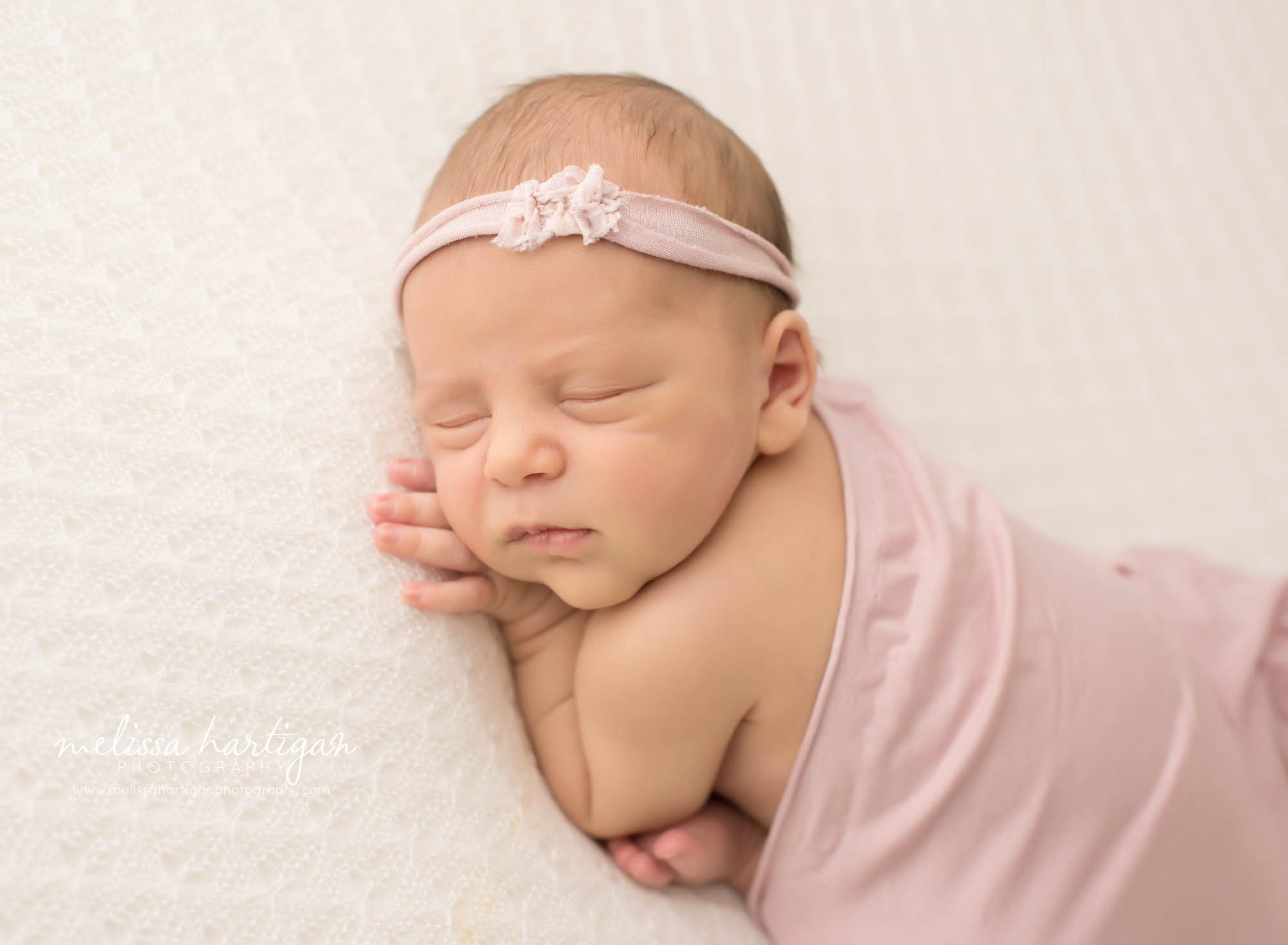 newborn baby girl posed on side wearing bow headband Newborn photography Widsor CT