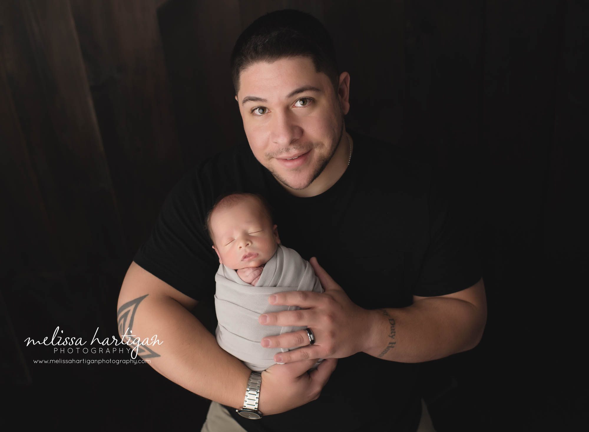 dad holding newborn son family pose newborn photography session in connecticut melissa hartigan photography