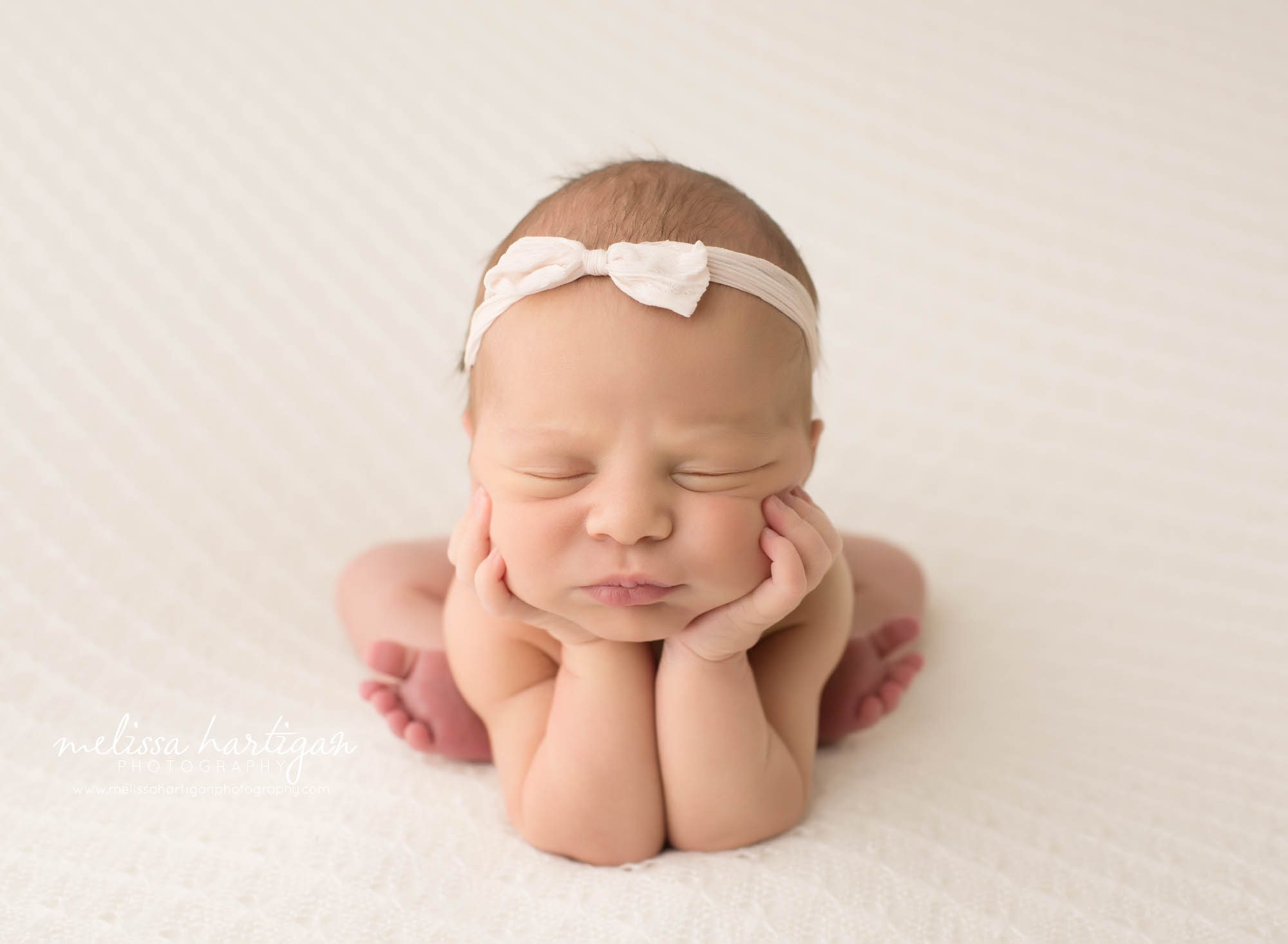 newborn baby girl posed froggy pose