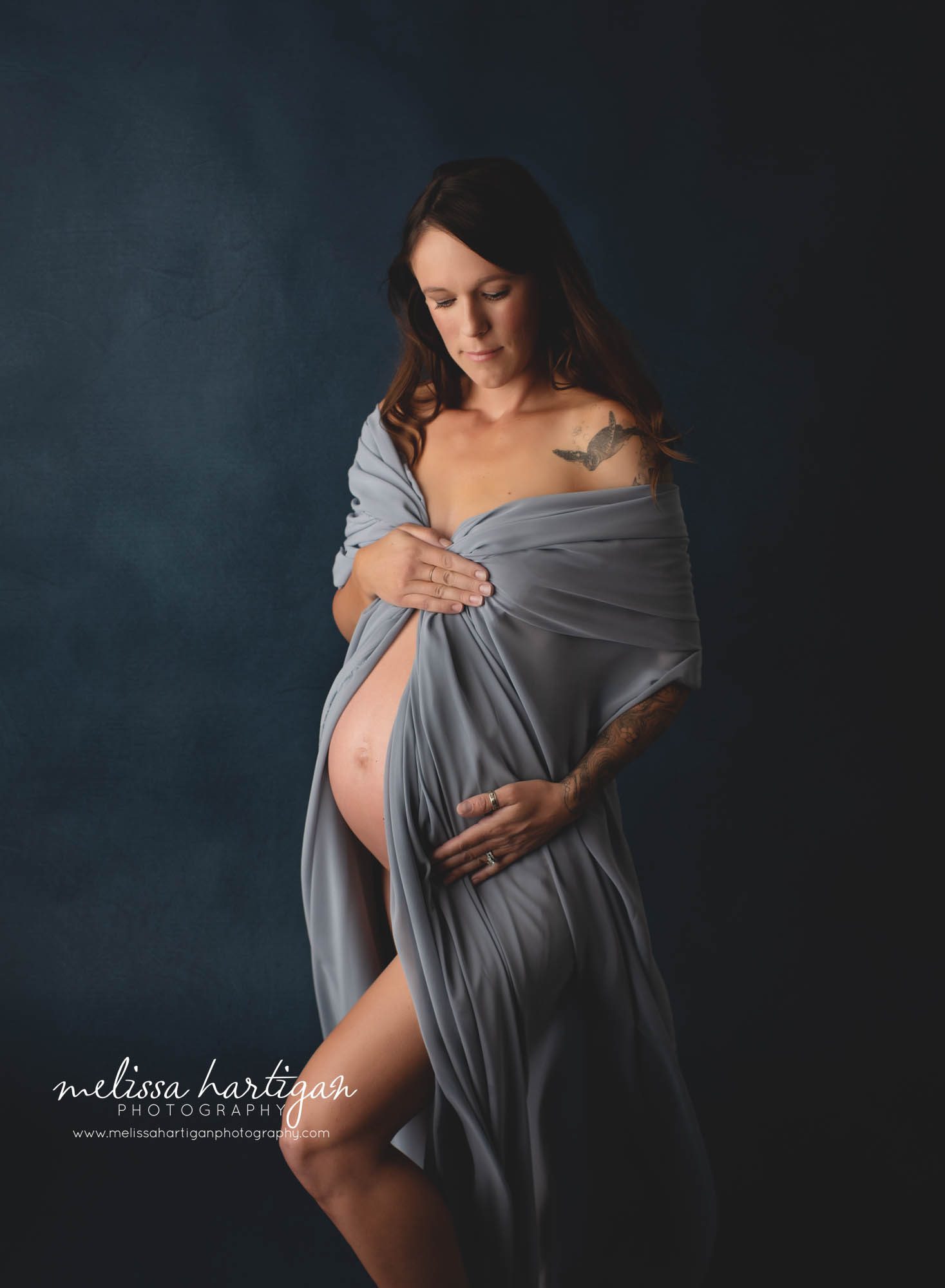 pregnant mom wearing blue drapped fabric studio maternity photography CT