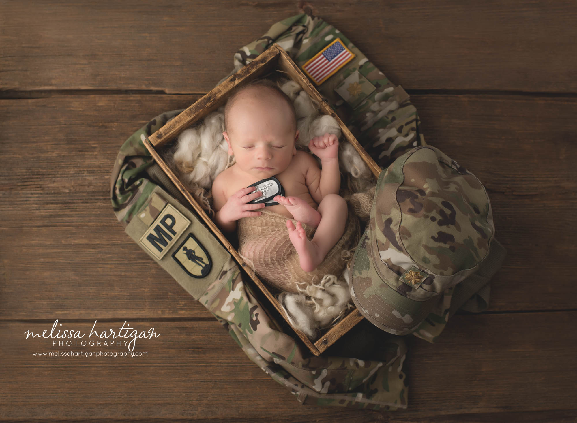 newborn baby boy posed with army reserve uniform and dogtags
