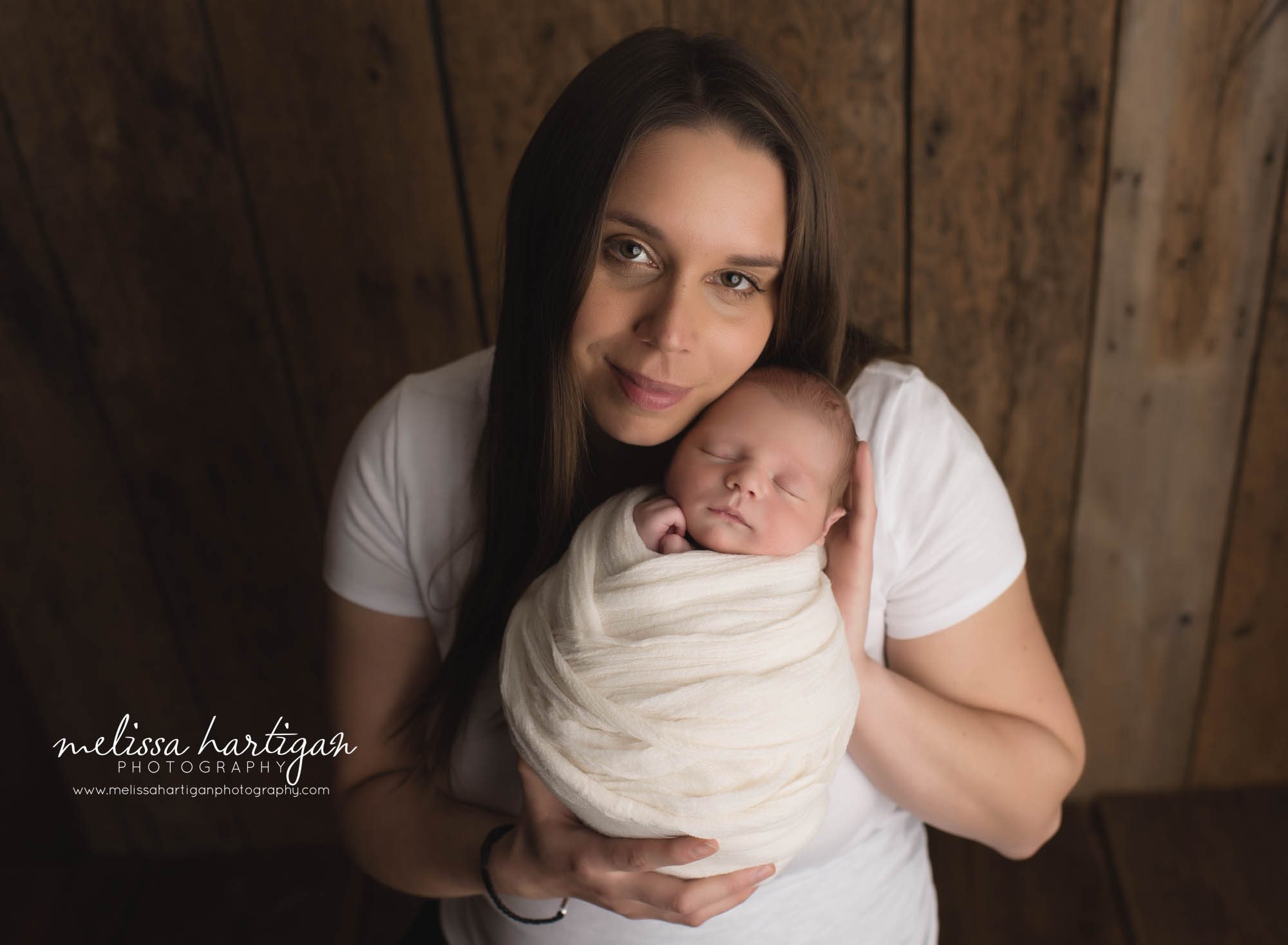 mom holding newborn son to cheek CT newborn photography