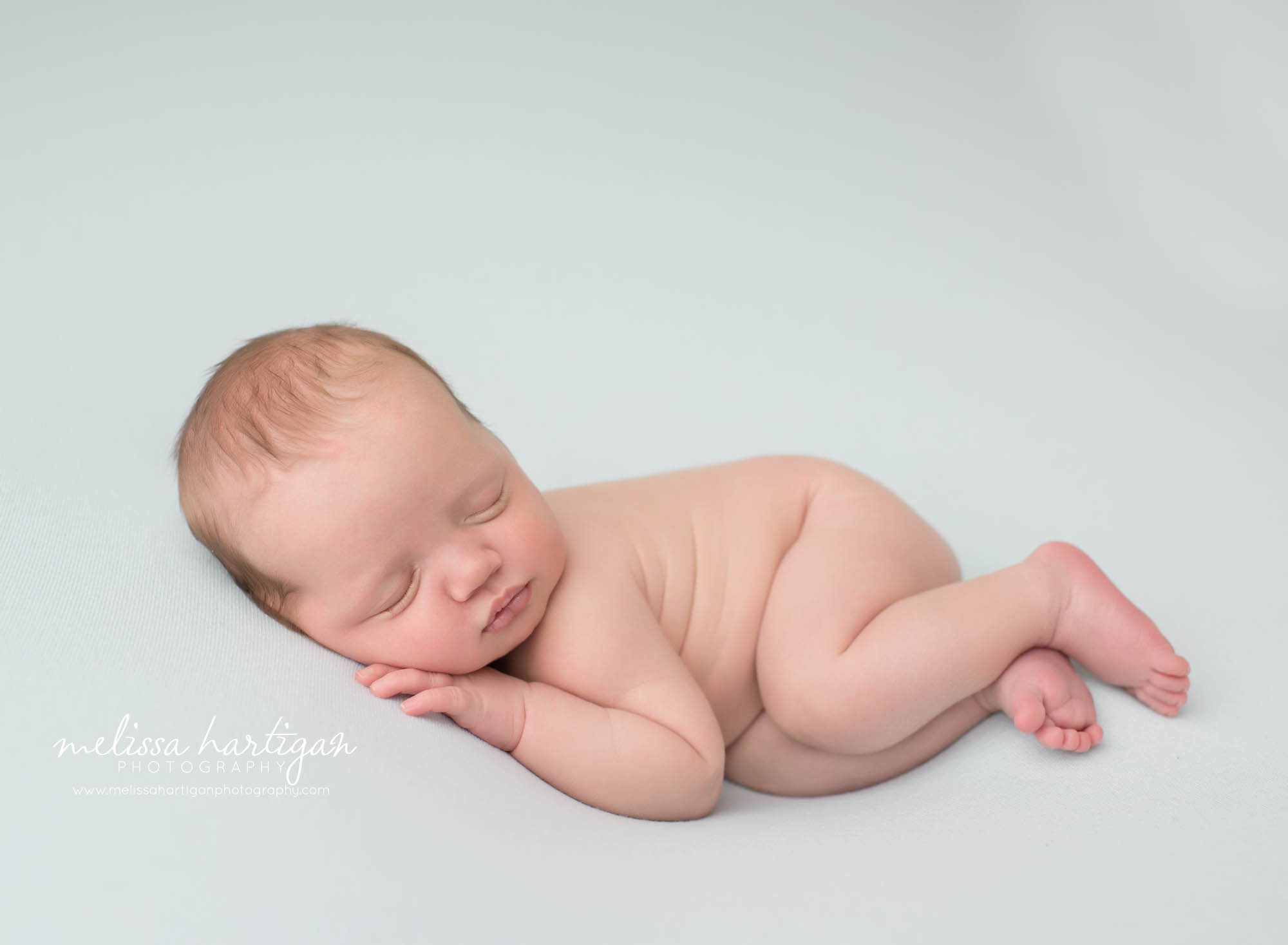 newborn baby boy posed on side sleeping tolldand county CT newborn photography