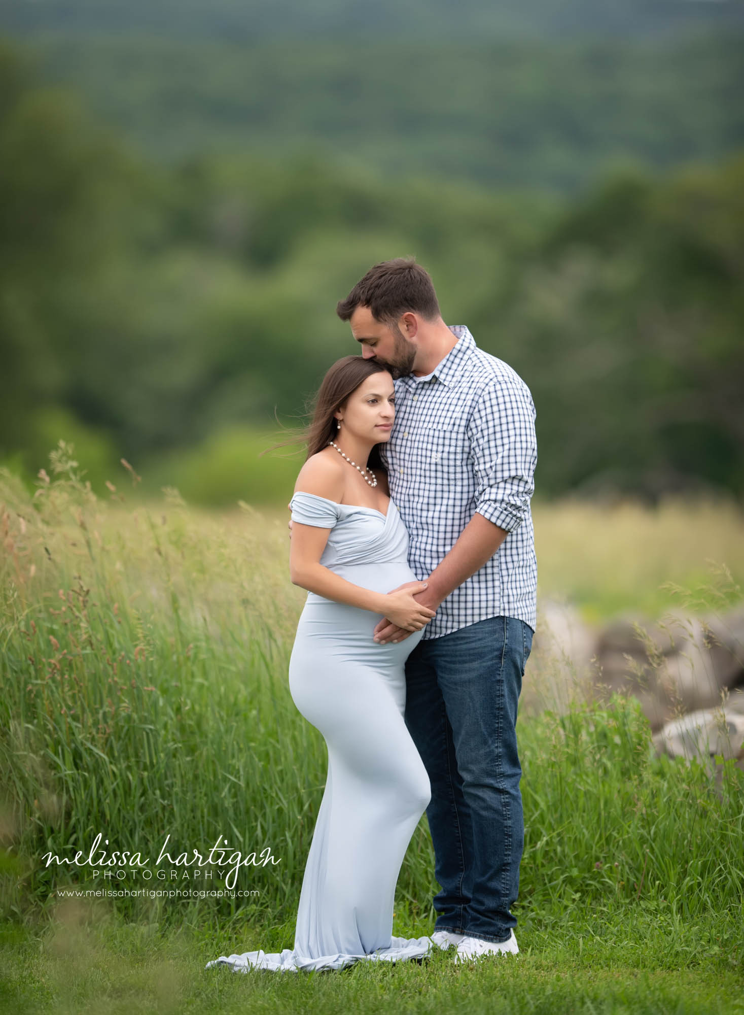 couple standing close together holding baby bump maternity photography CT