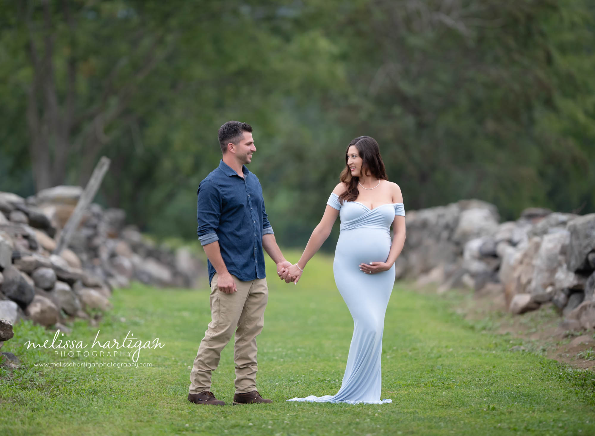 couple holding hands outside pregnancy photoshoot Connecticut maternity photographer