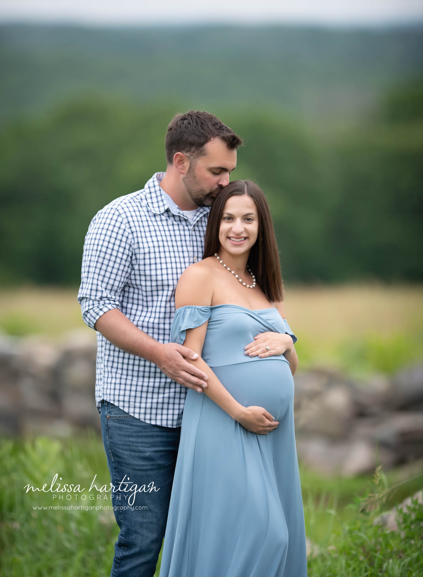 pregnant mom getting kissed on the head by dad to be CT maternity photography