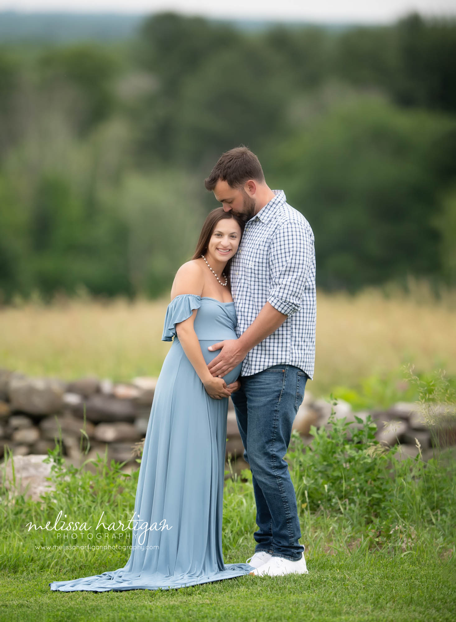 expectant couple standing outside maternity photography CT