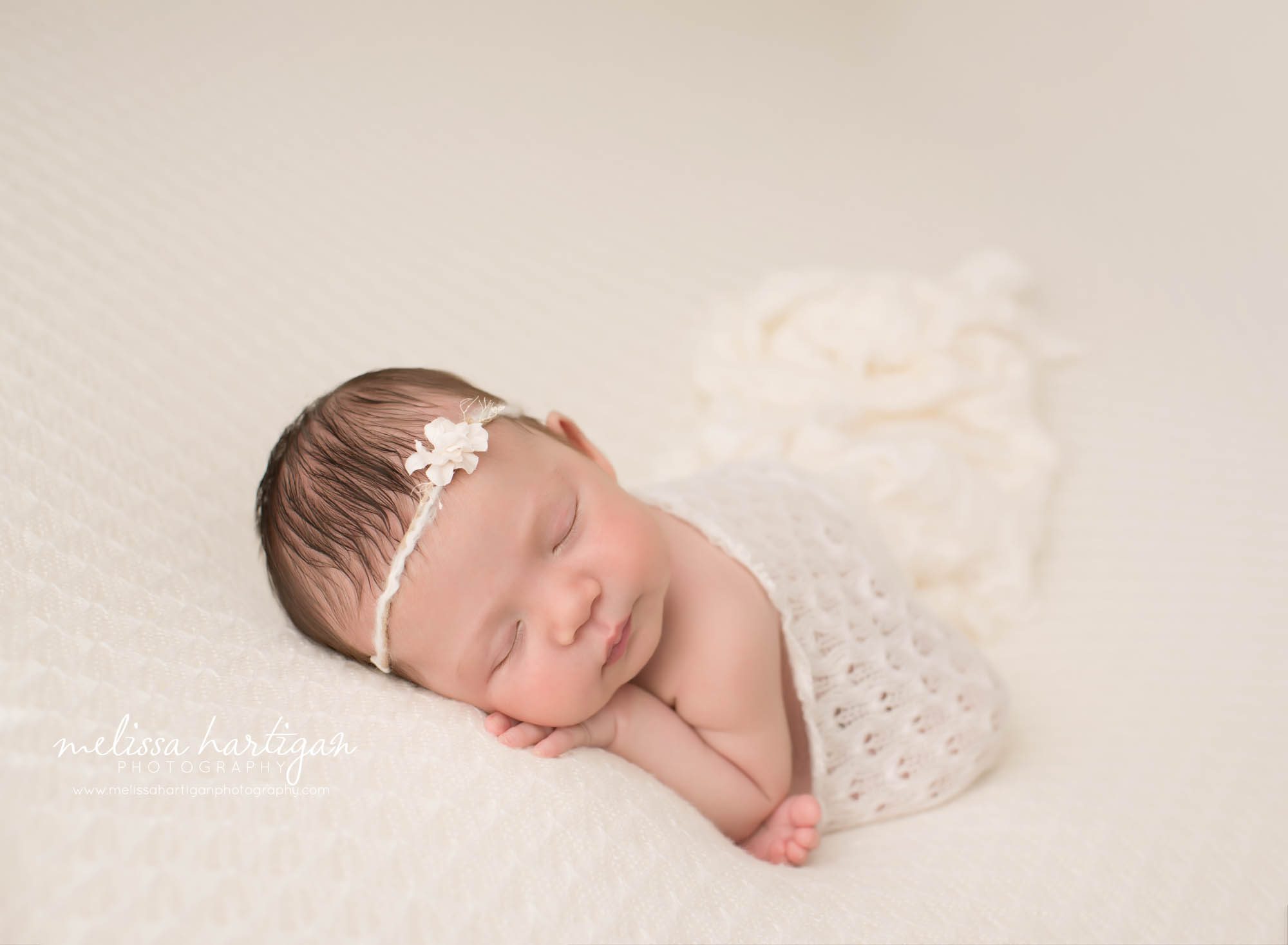 newborn baby girl posed on tummy with knitted lace wrap draped over back new haven county newborn photogaphy