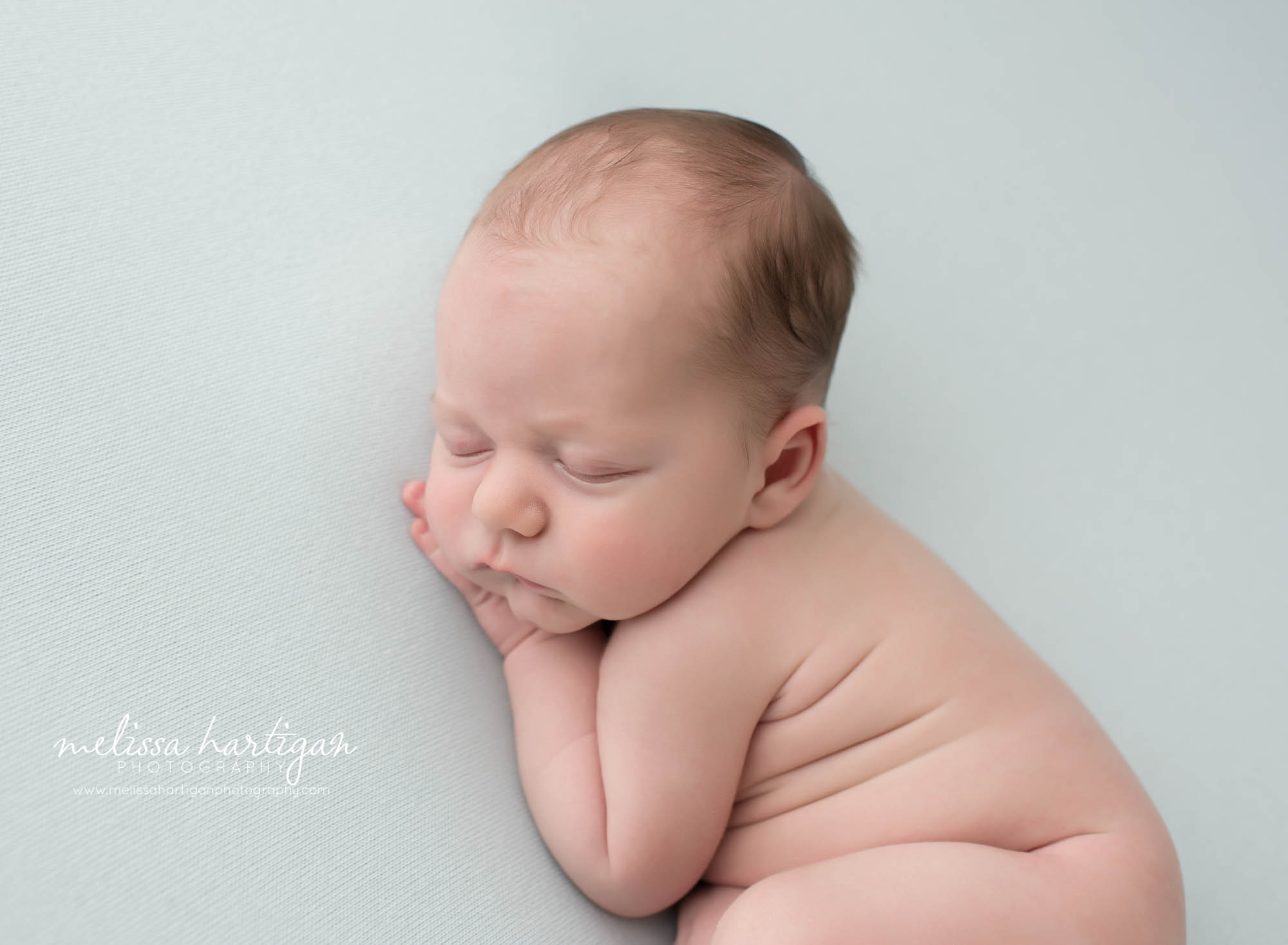 newborn babgy boy posed on side with hand under chin sleeping CT newborn photography