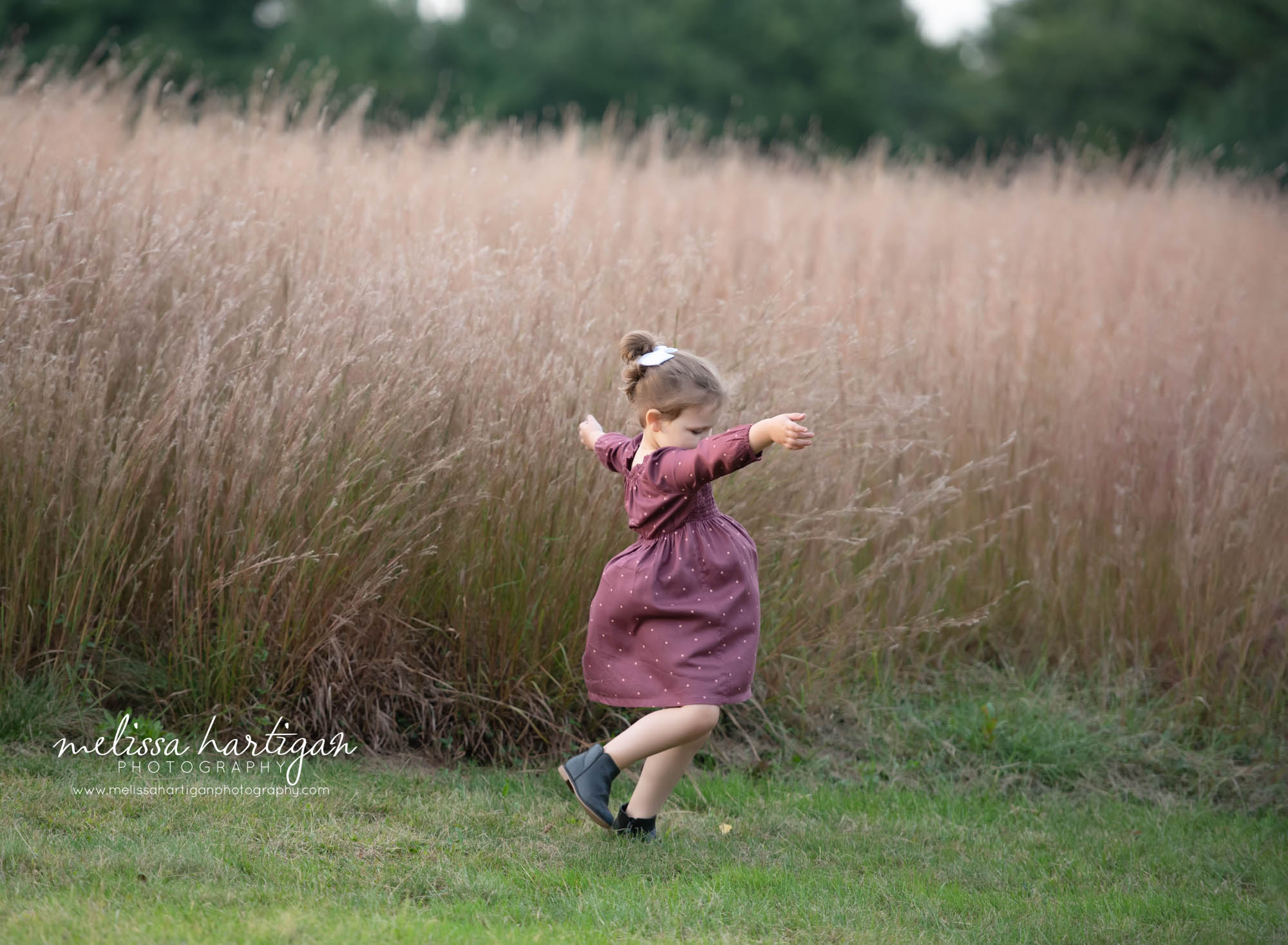 little girl twirling skipping in field family photography ledyard CT