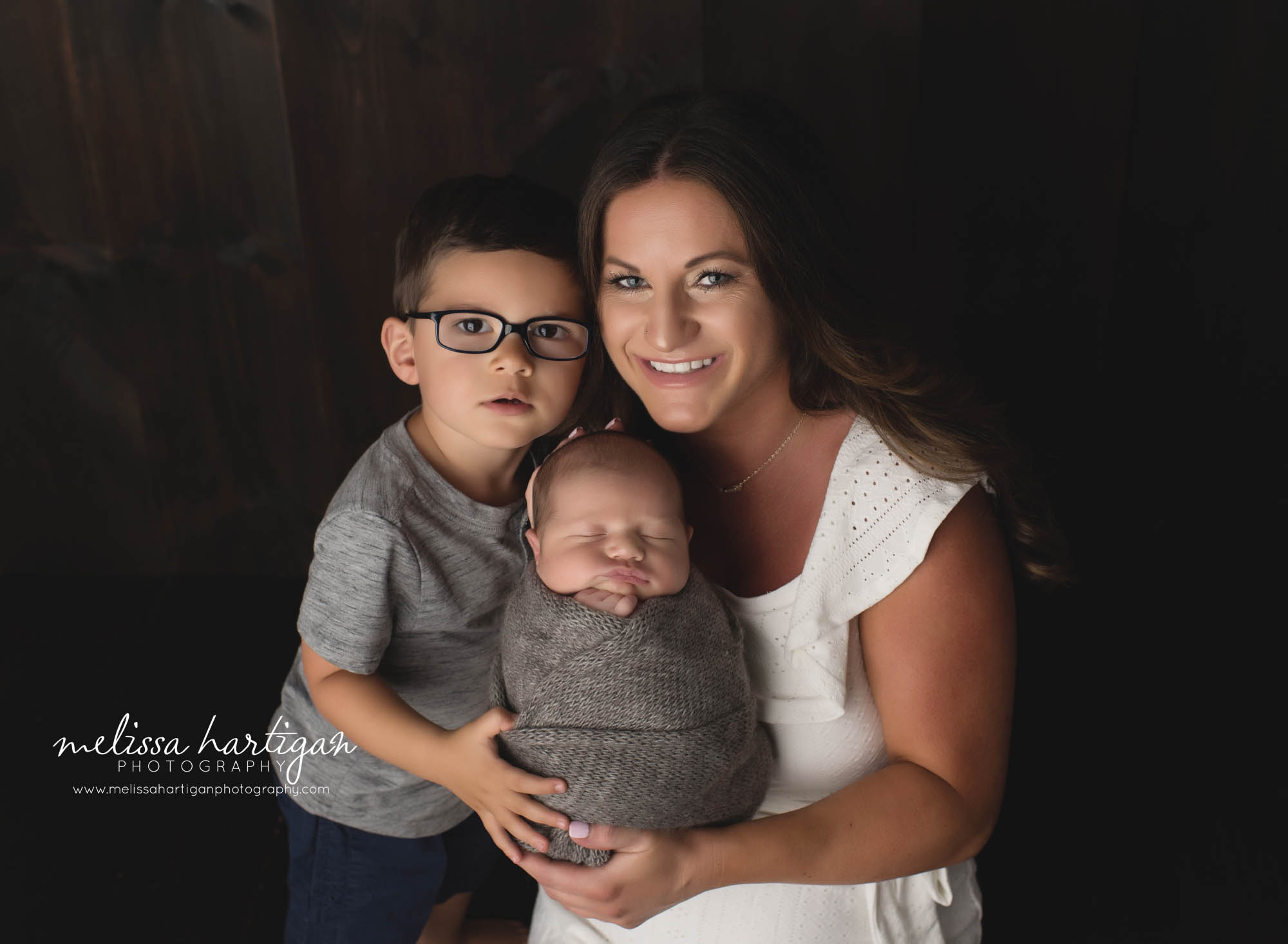 mom holding older son and newborn son family picture CT newborn photography